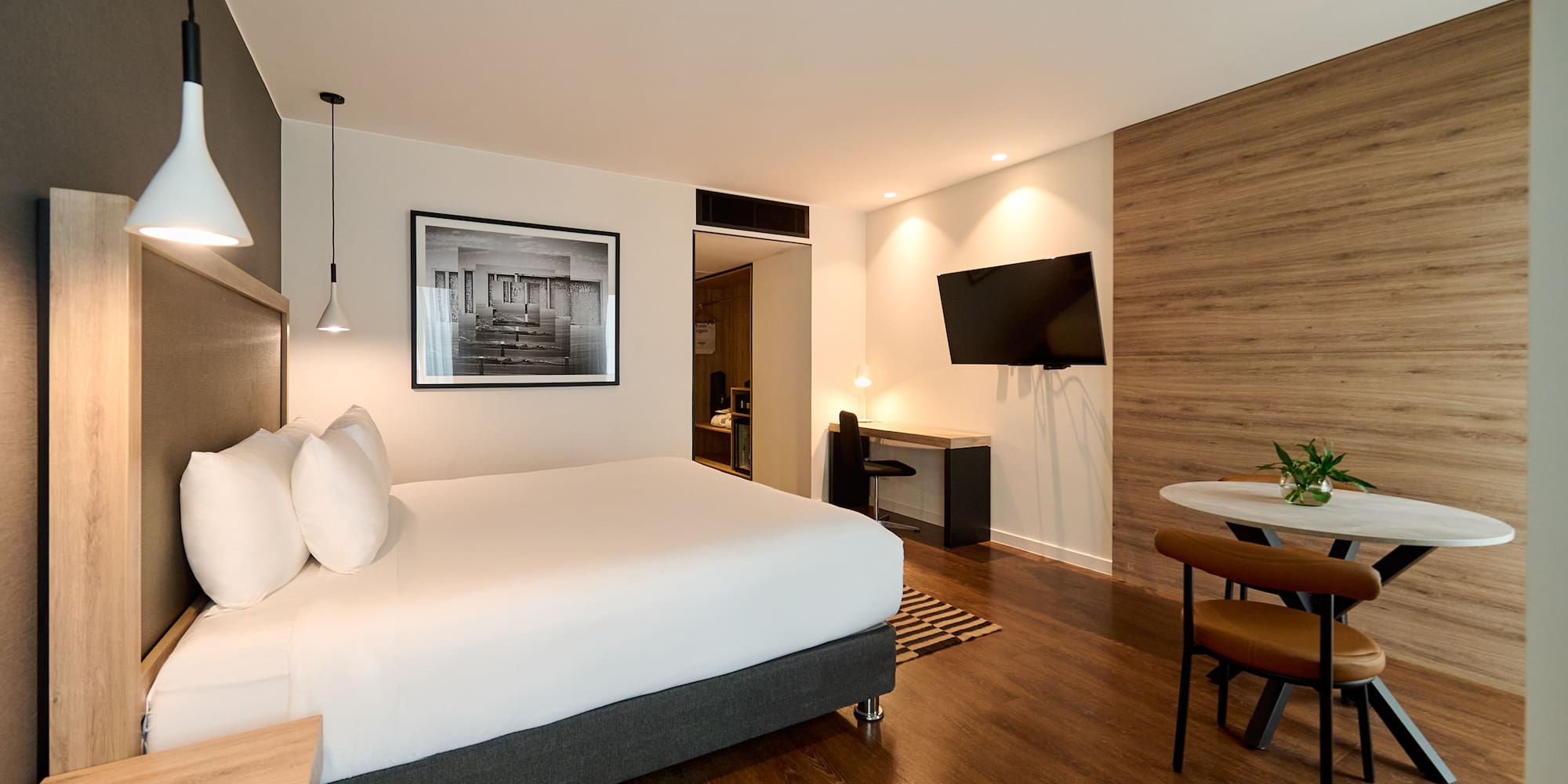 a room with a bed and a television