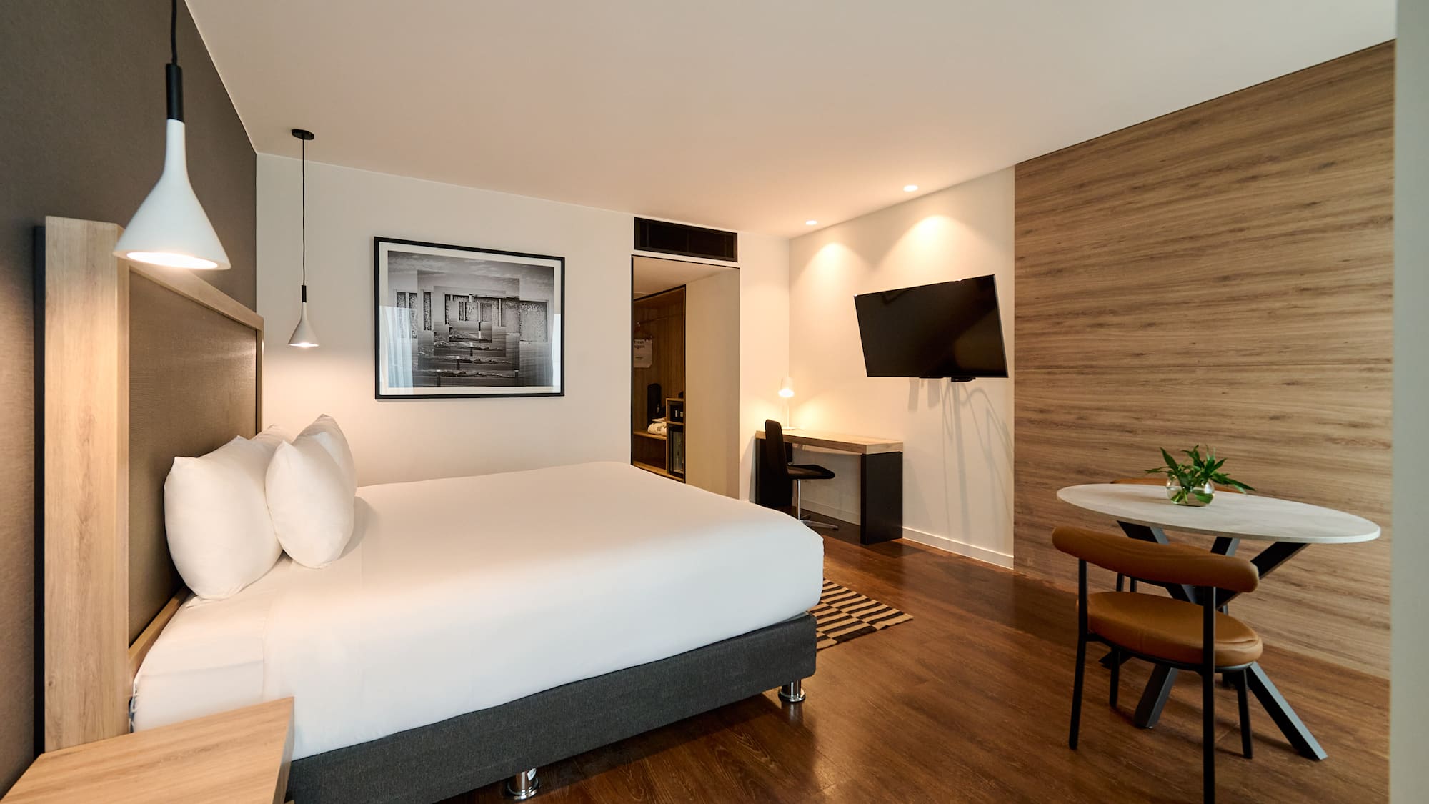 a room with a bed and a television