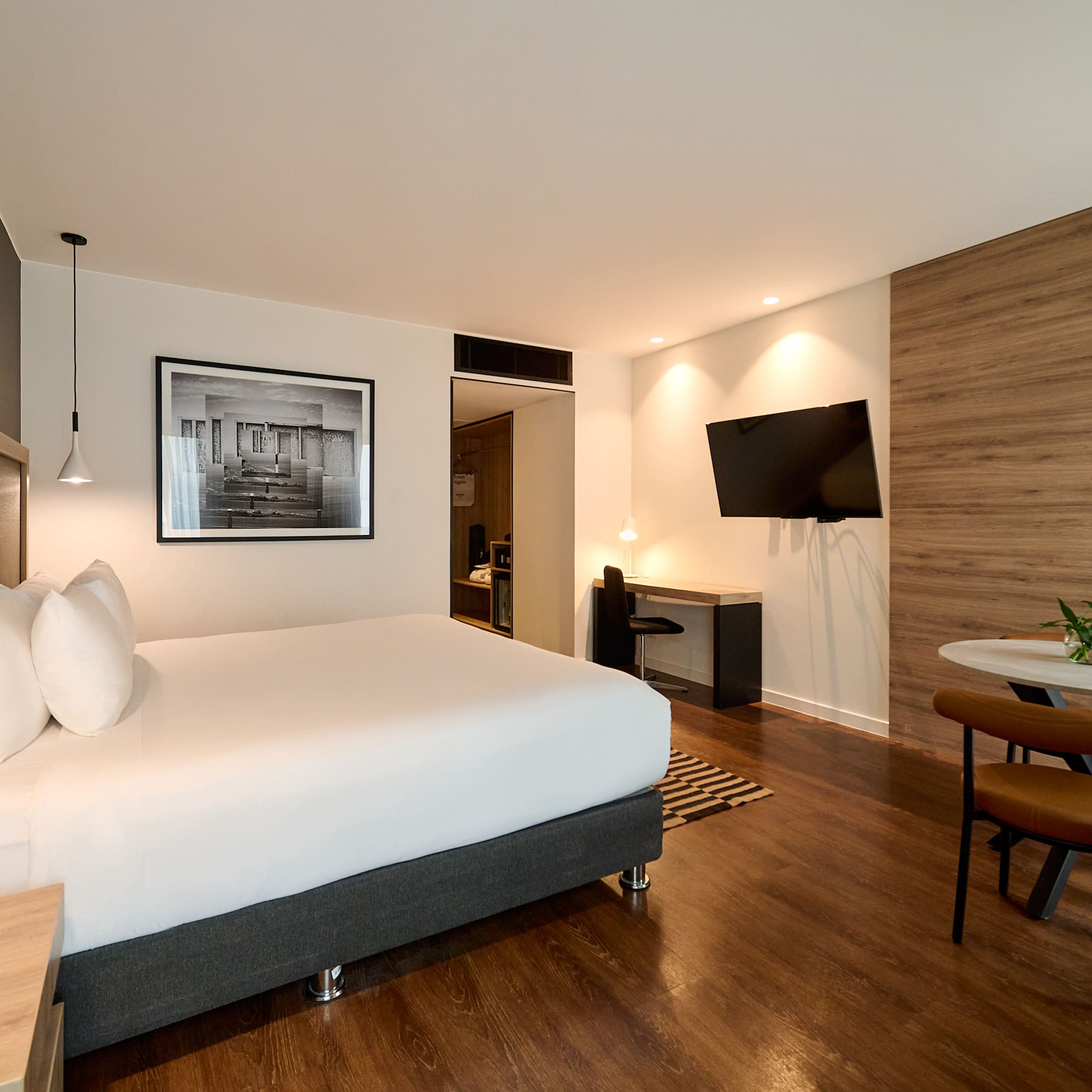 a room with a bed and a television