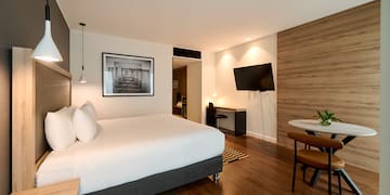 a room with a bed and a television