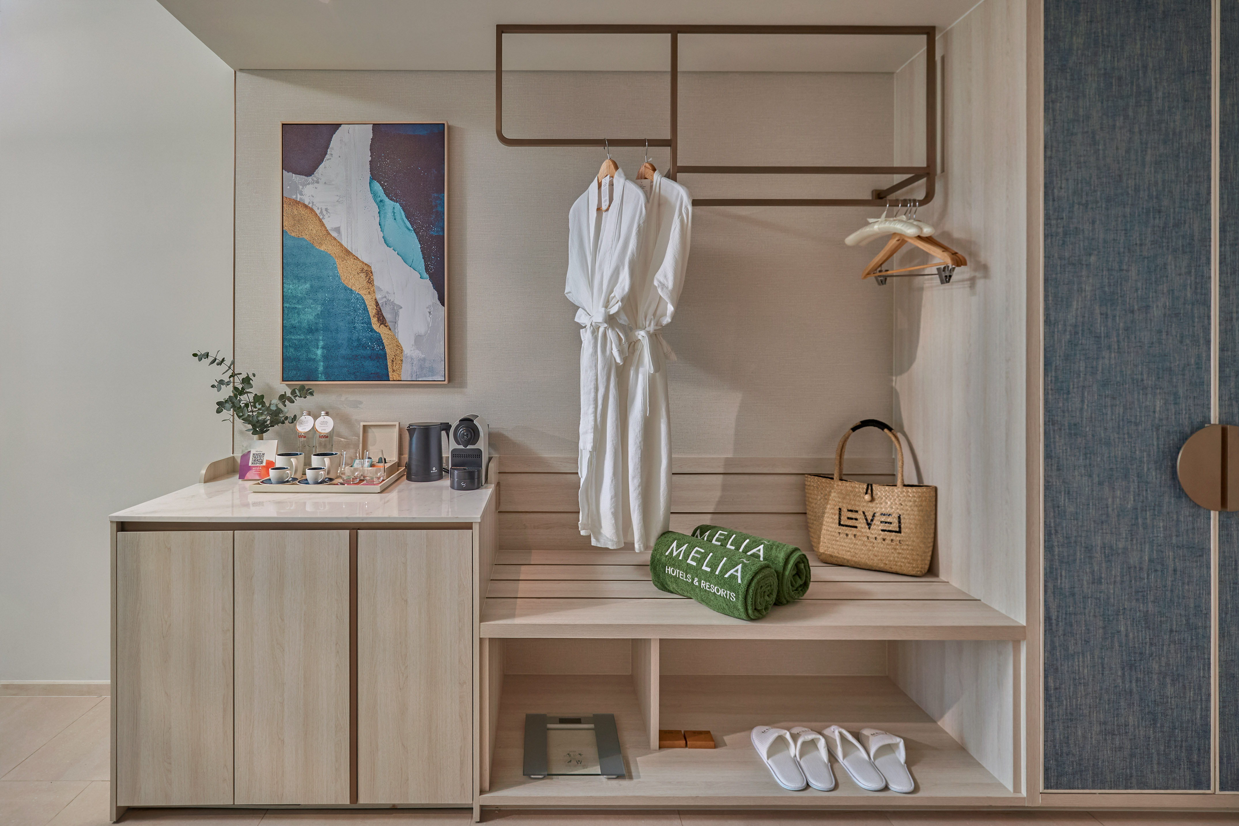 Modern Melia hotel room amenities: bathrobes, coffee bar, towels, slippers.