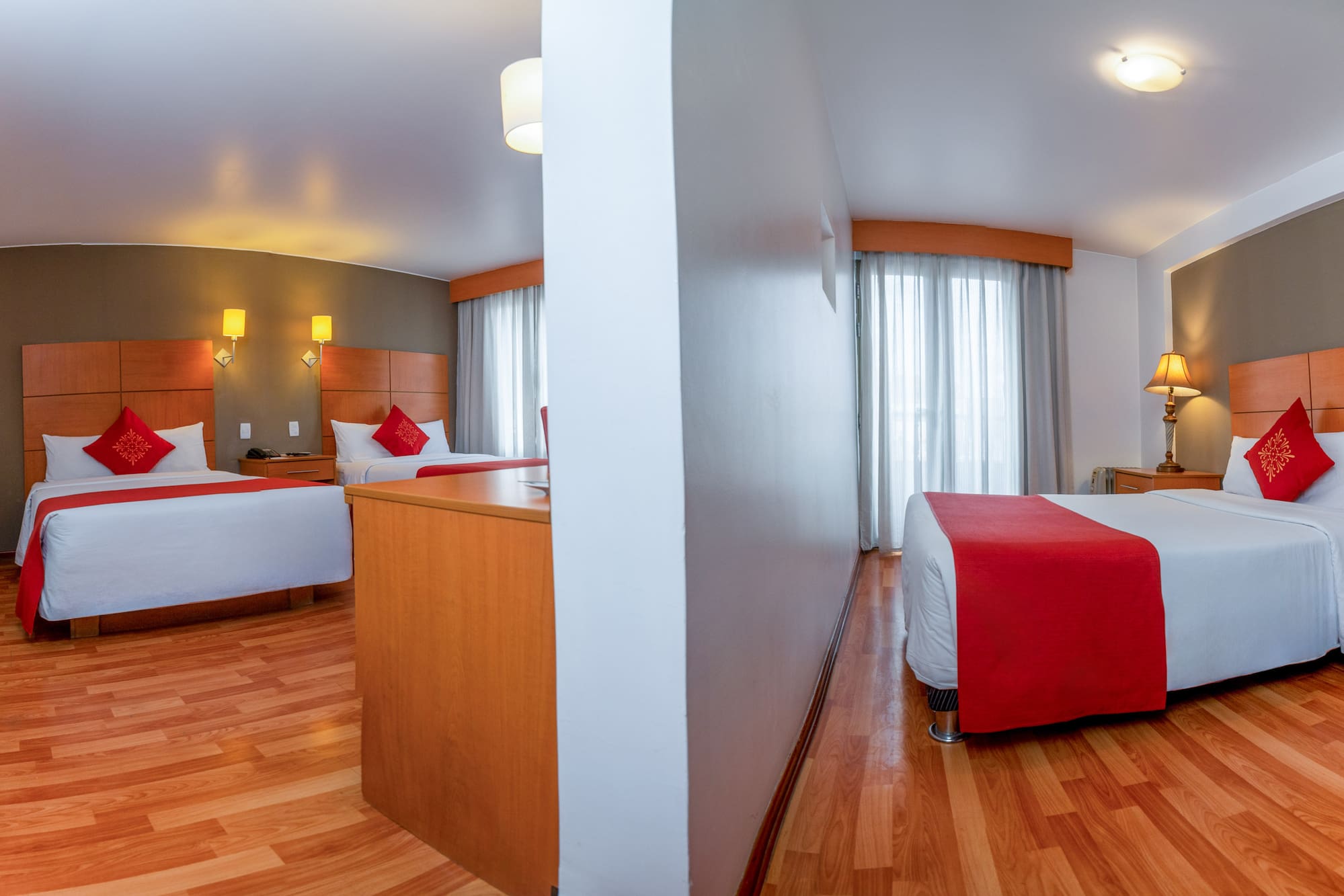 a room with two beds and a wood floor
