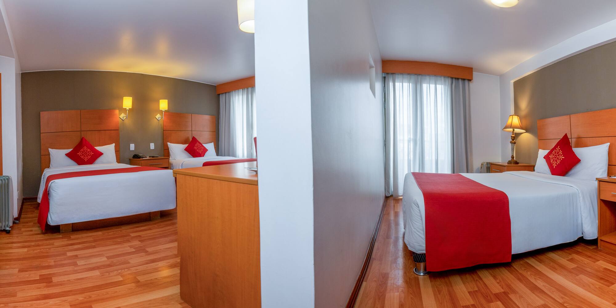 a room with two beds and a wood floor