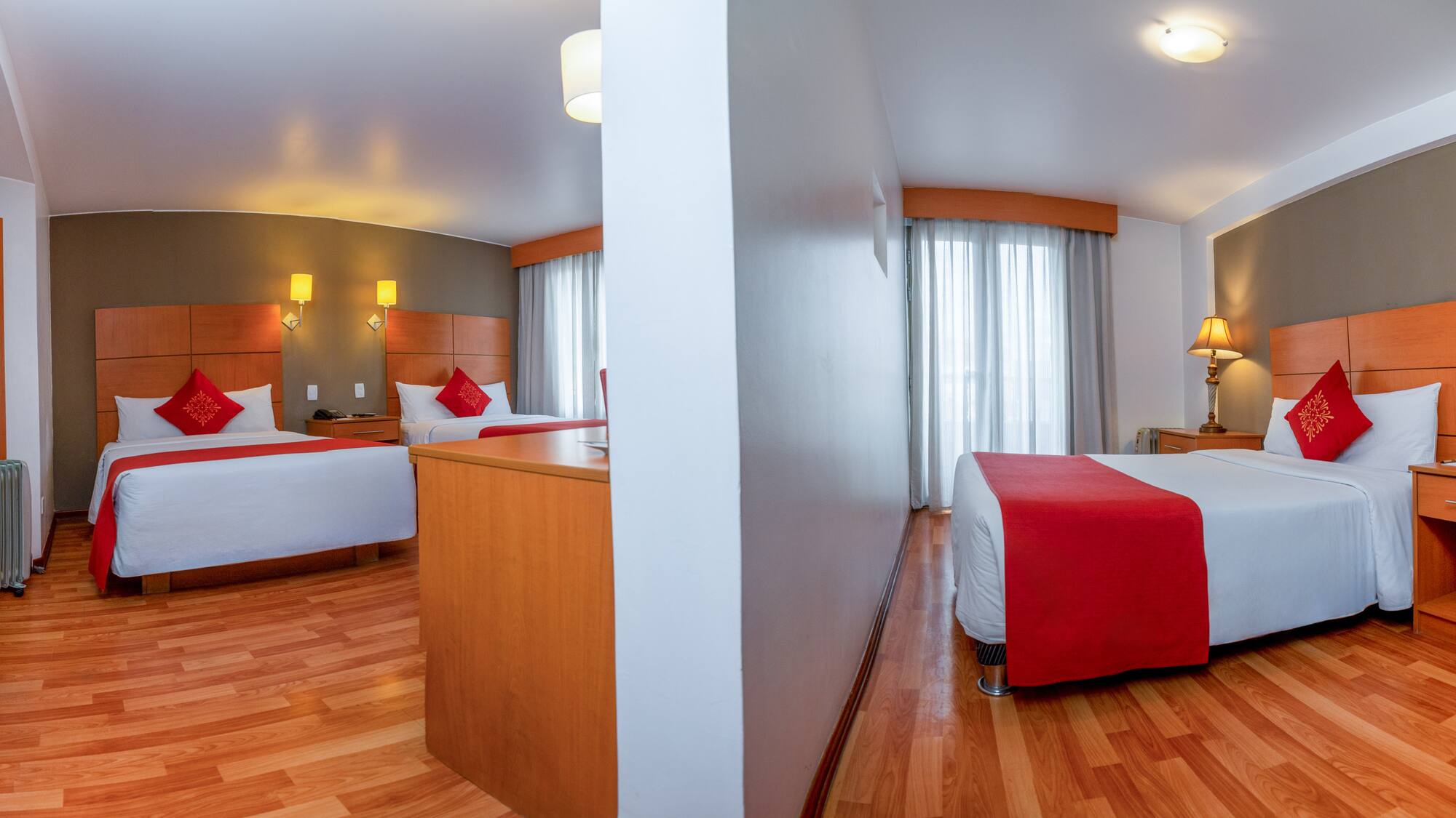 a room with two beds and a wood floor