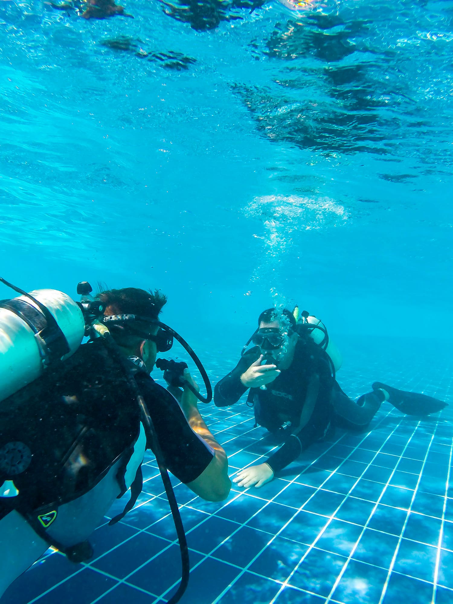 a group of people underwater in a pool