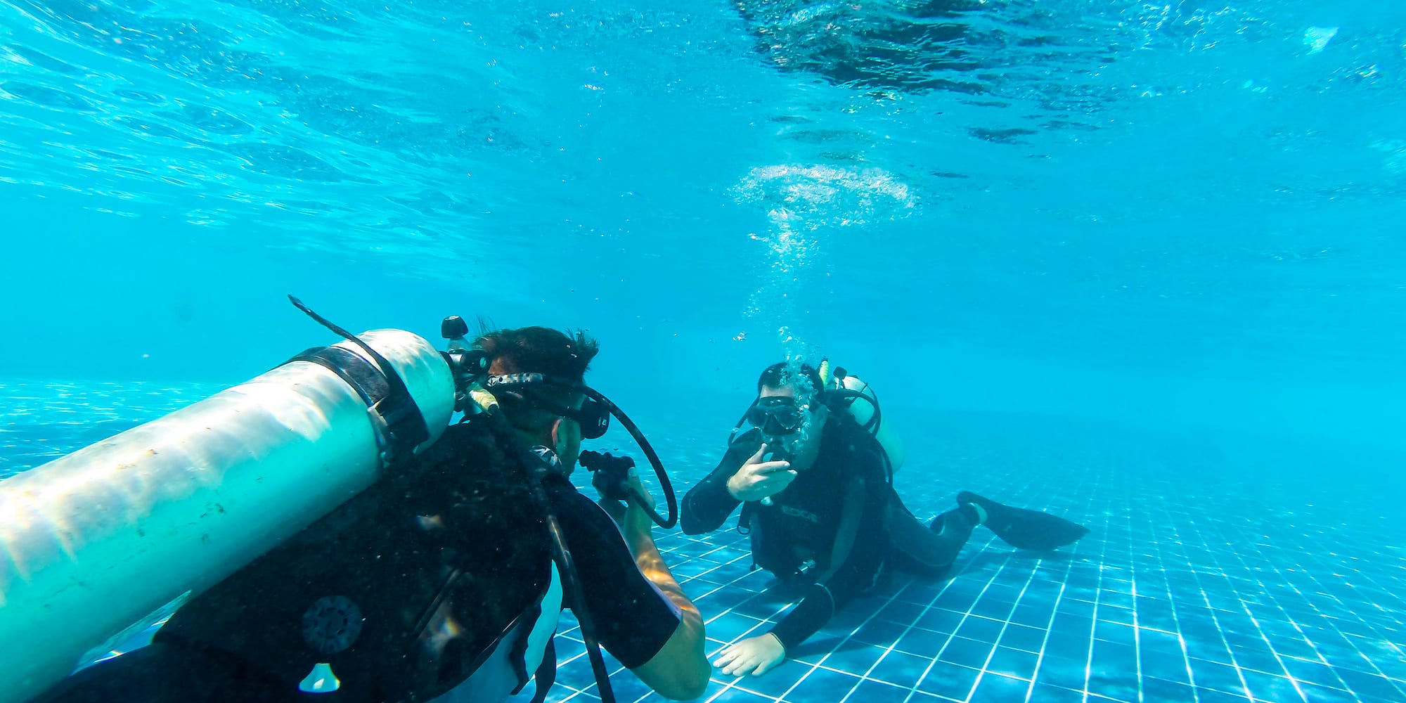a group of people underwater in a pool