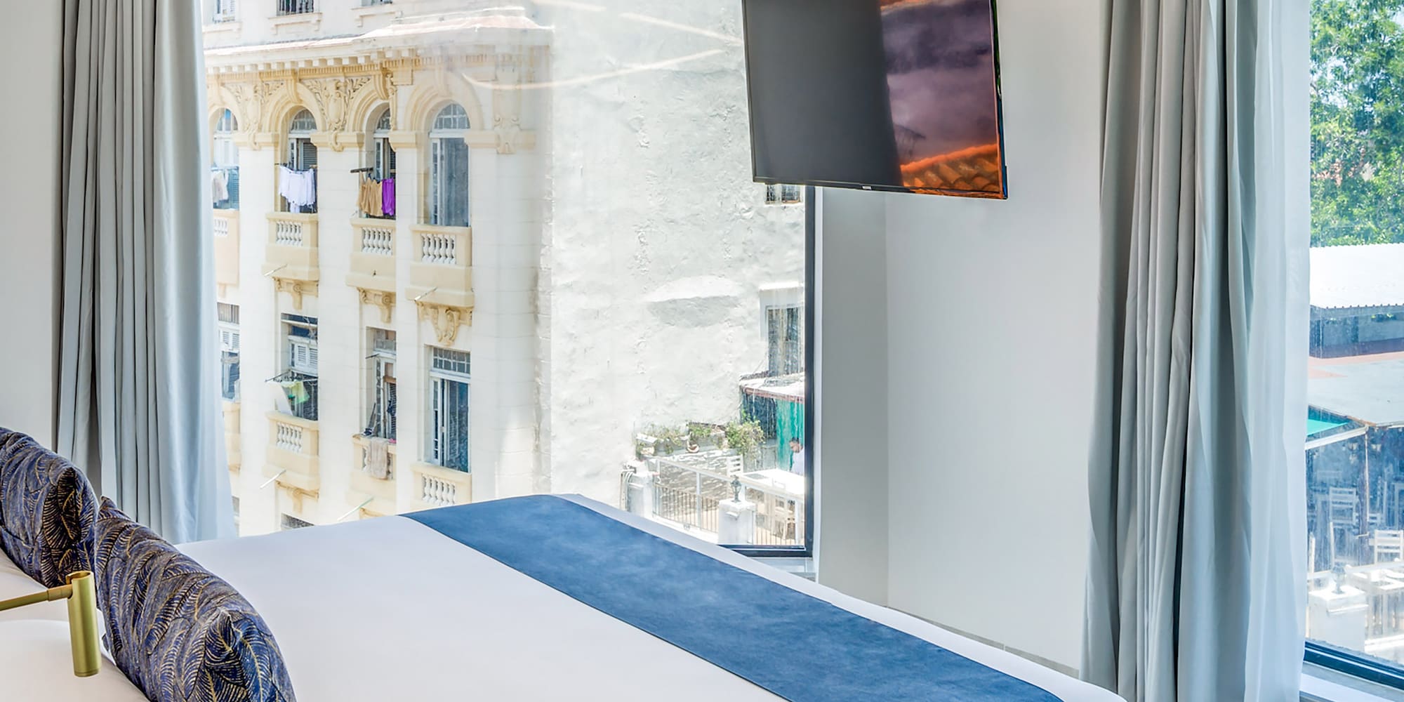 a bedroom with a large bed and a television