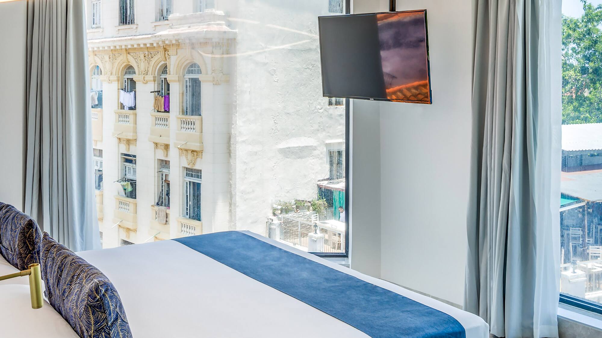 a bedroom with a large bed and a television