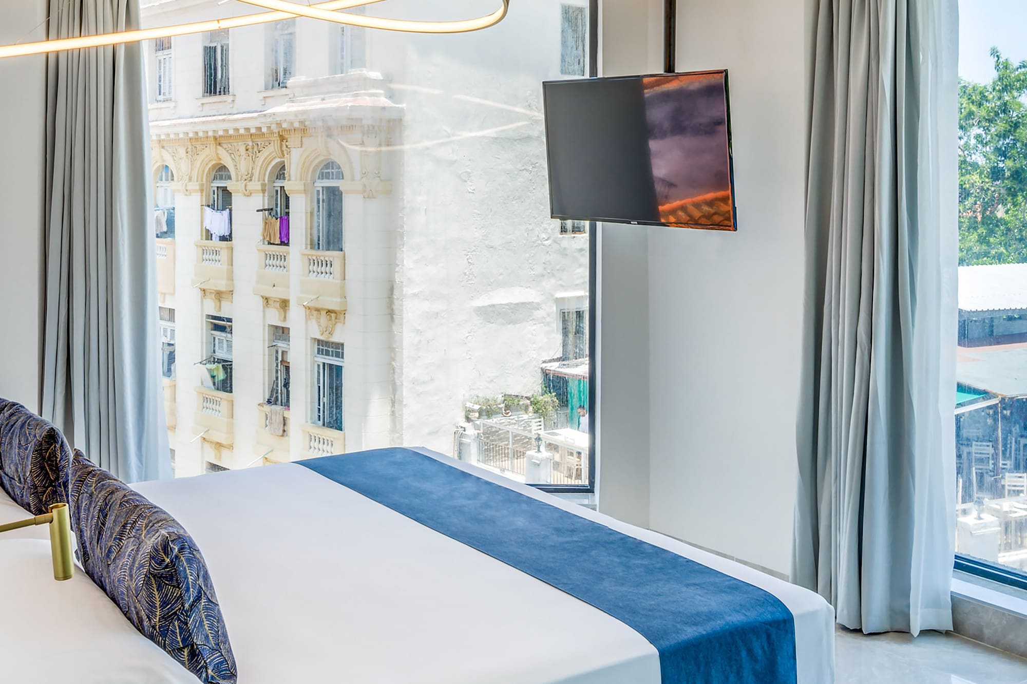 a bedroom with a large bed and a television