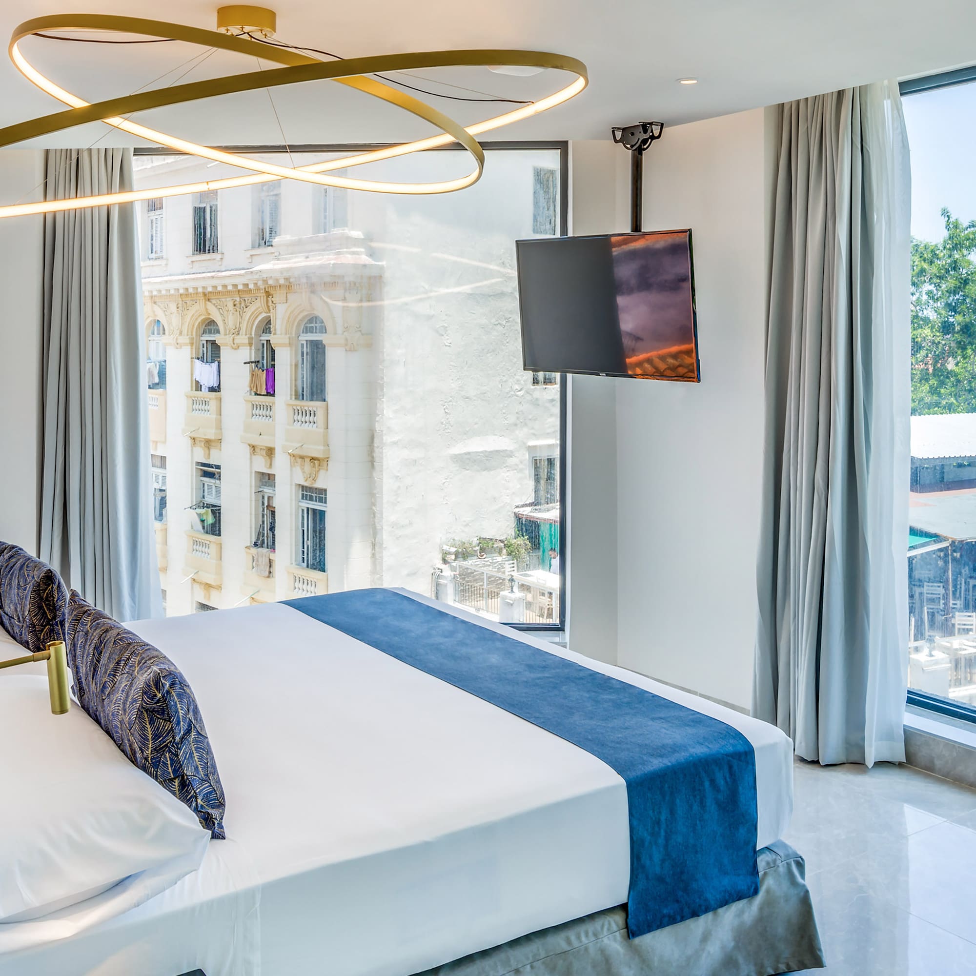 a bedroom with a large bed and a television