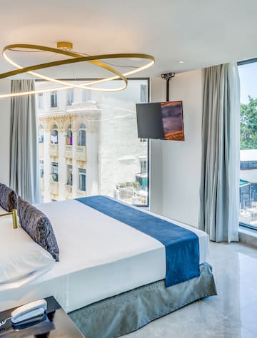 a bedroom with a large bed and a television