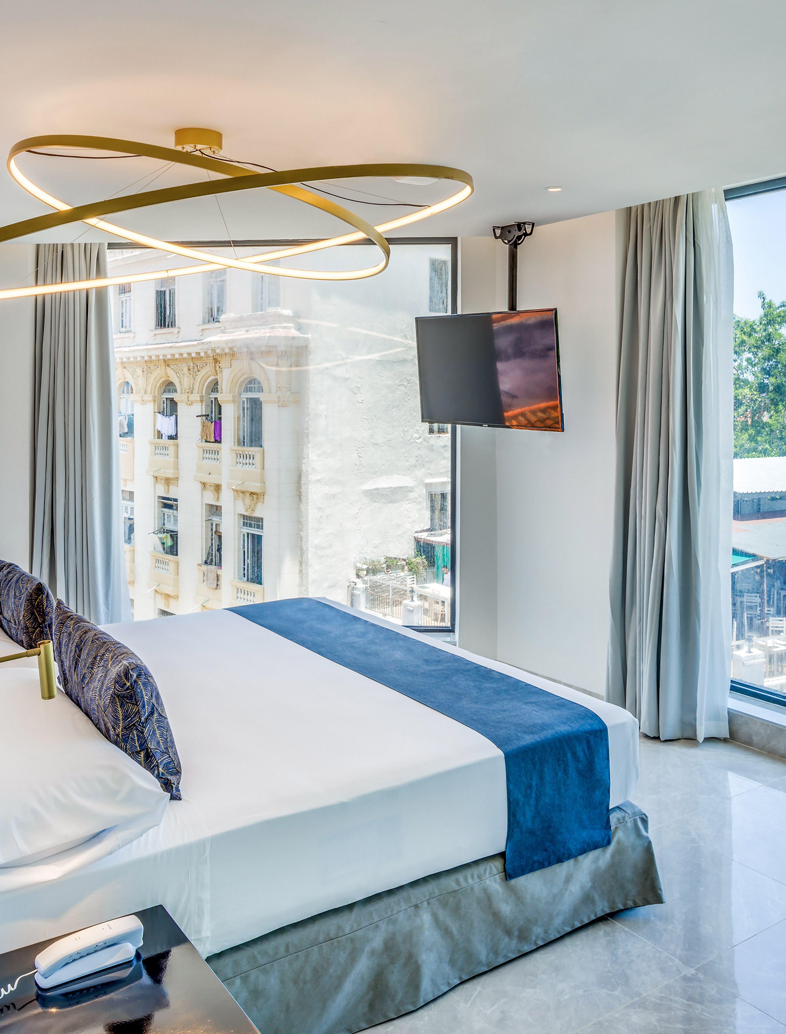 a bedroom with a large bed and a television