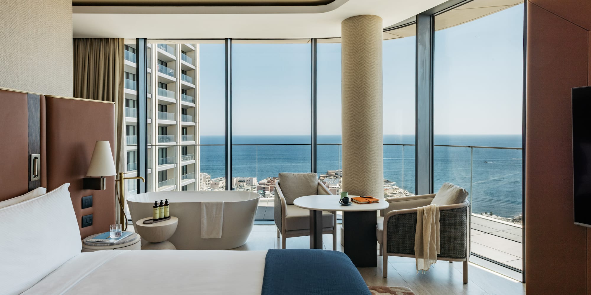 a room with a large window overlooking the ocean