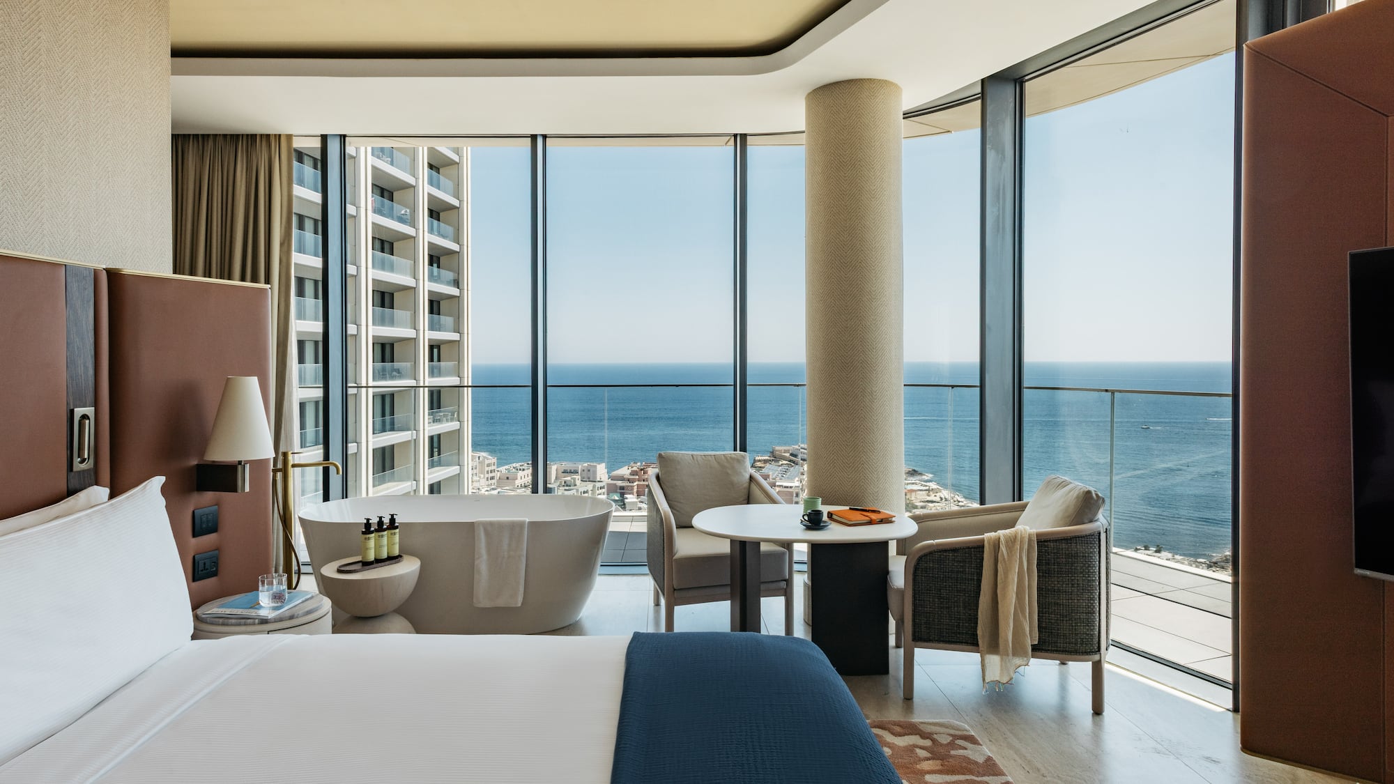 a room with a large window overlooking the ocean