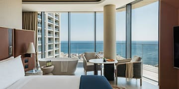 a room with a large window overlooking the ocean