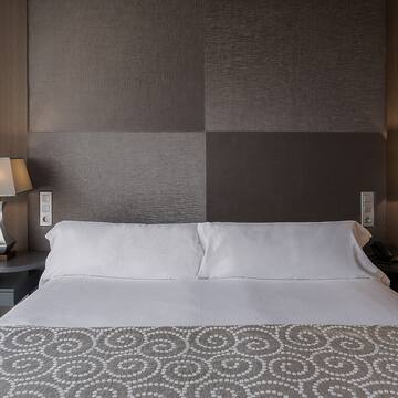 a bed with a lamp and a table