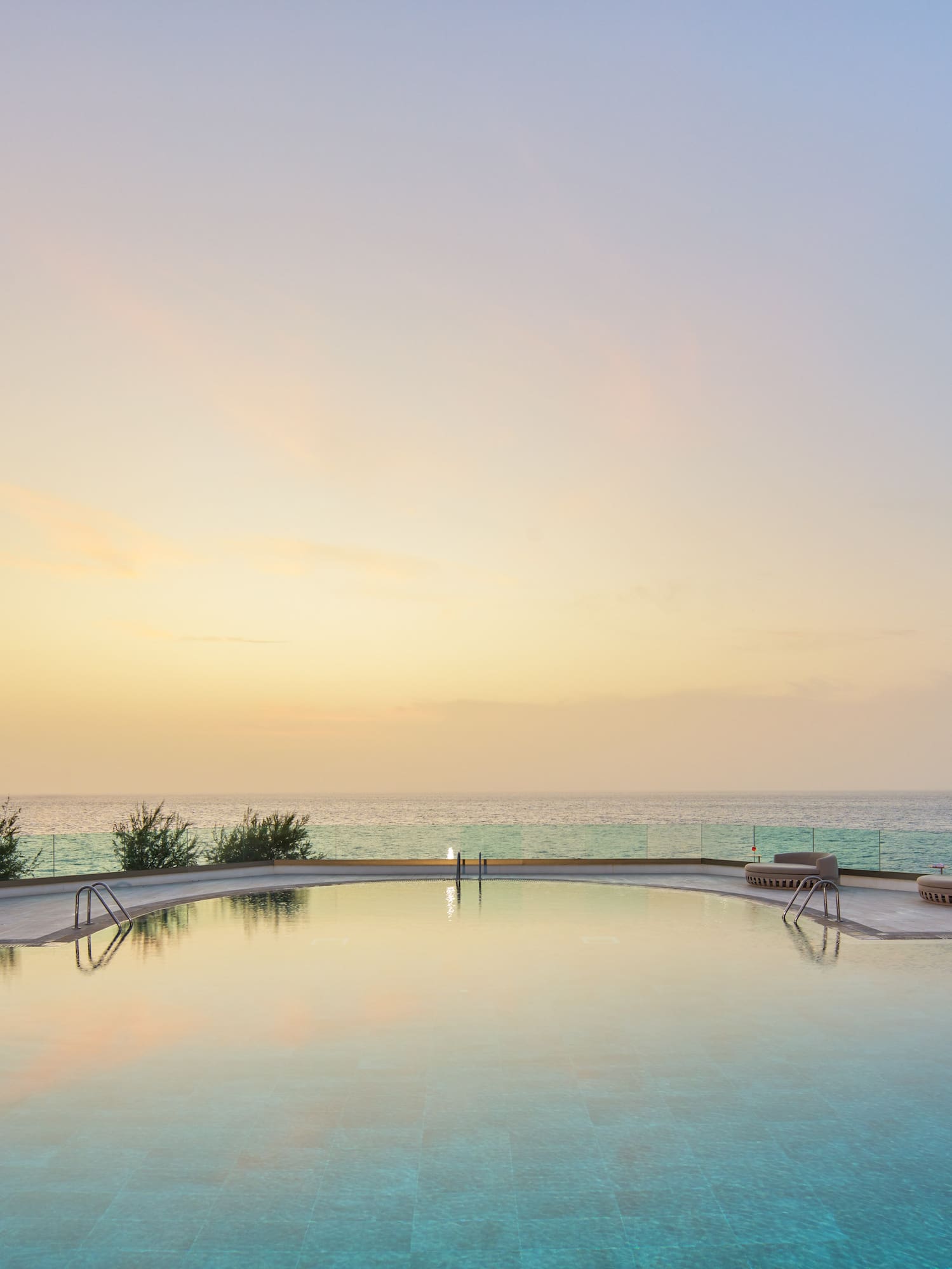 a pool with a body of water in the background