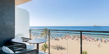 a balcony with a beach and a view of the ocean