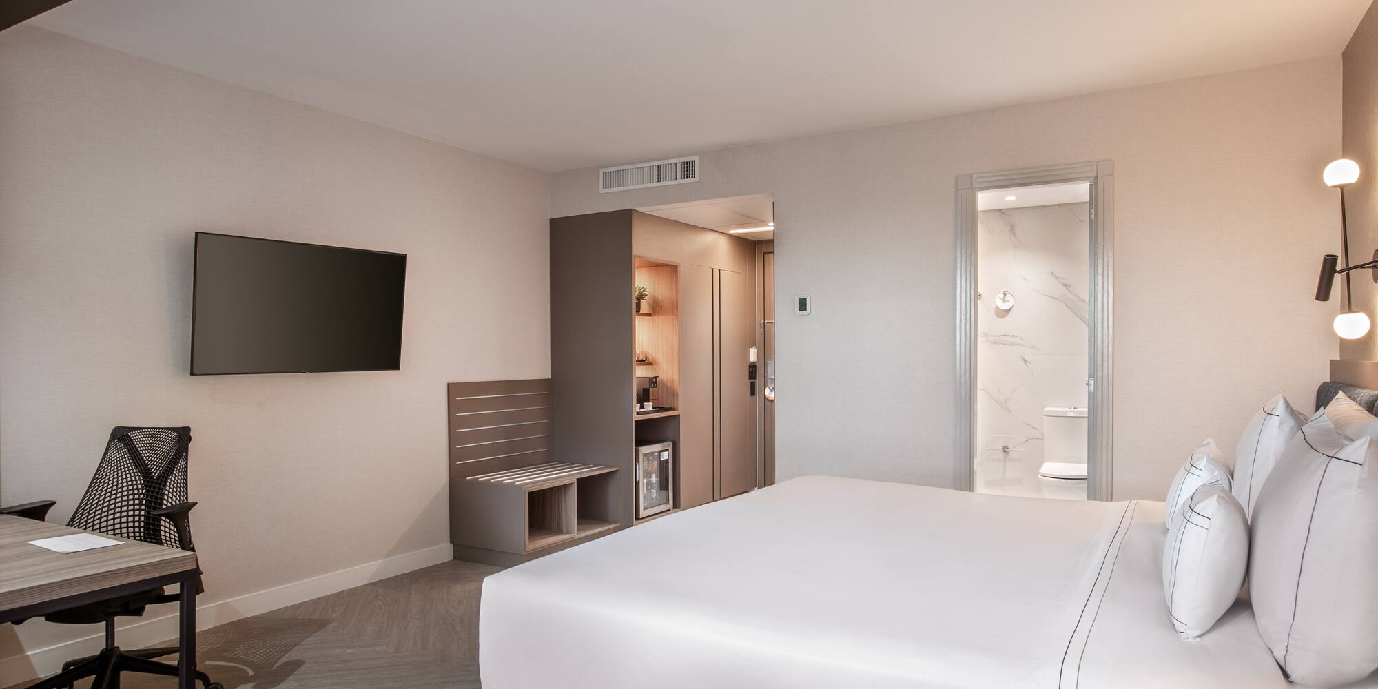 a room with a bed and a television