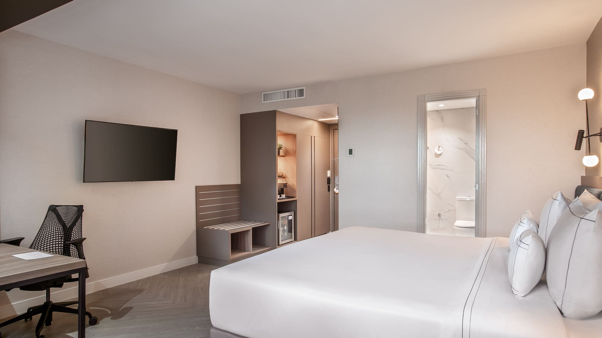 a room with a bed and a television