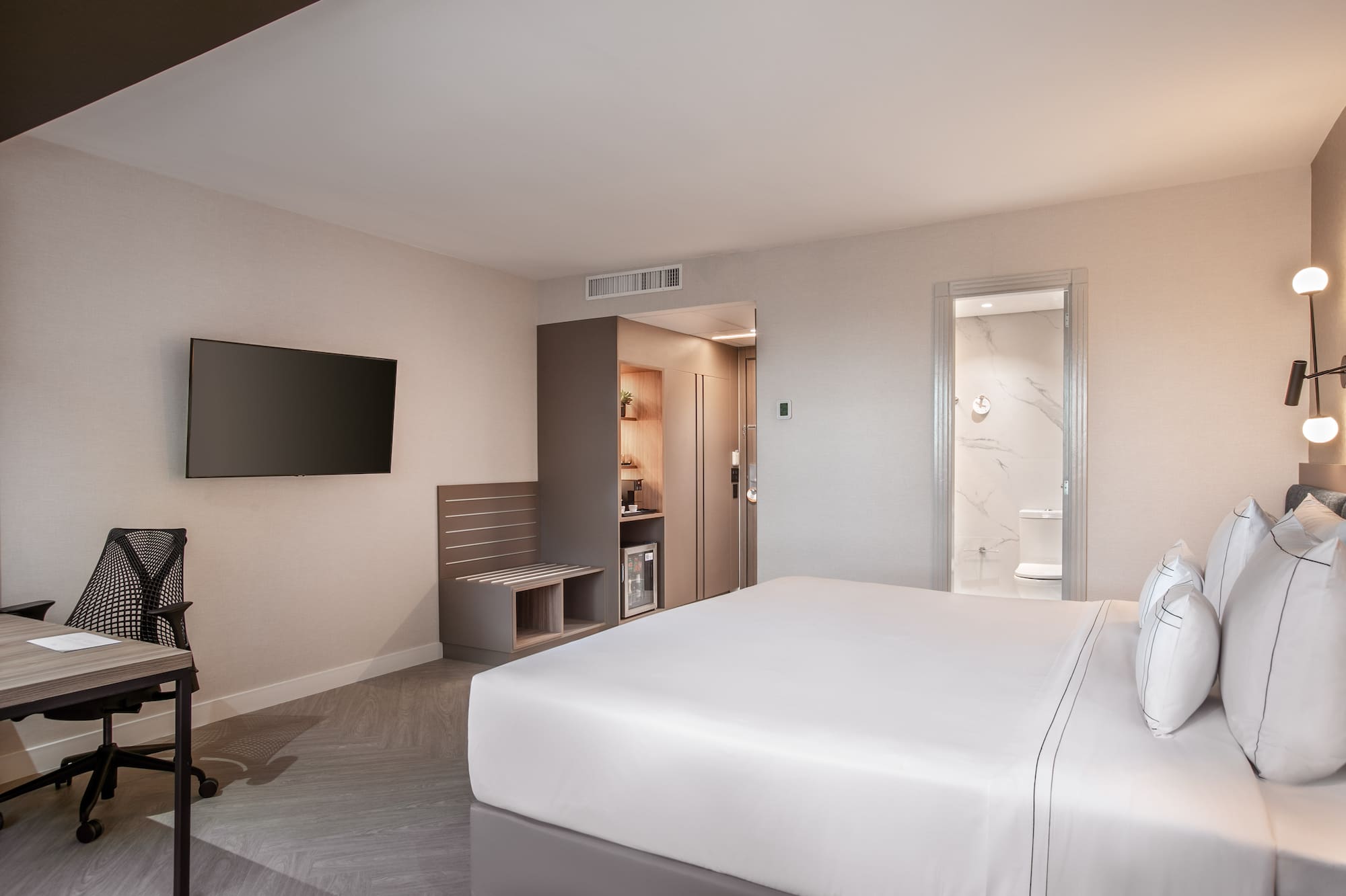 a room with a bed and a television