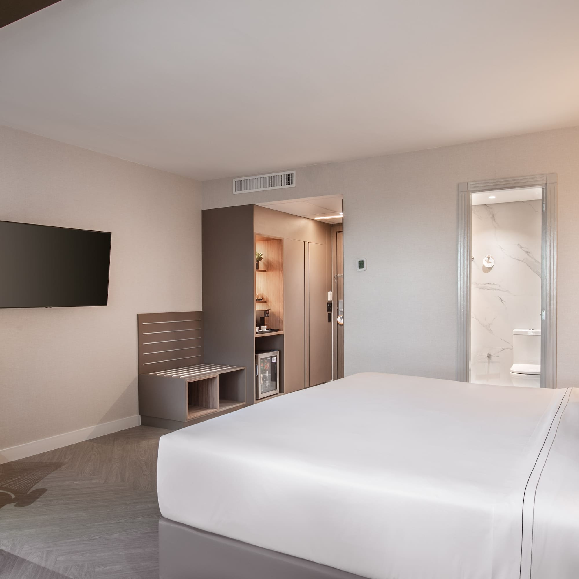 a room with a bed and a television