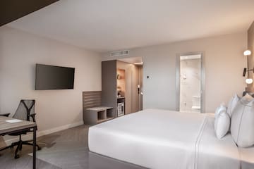 a room with a bed and a television