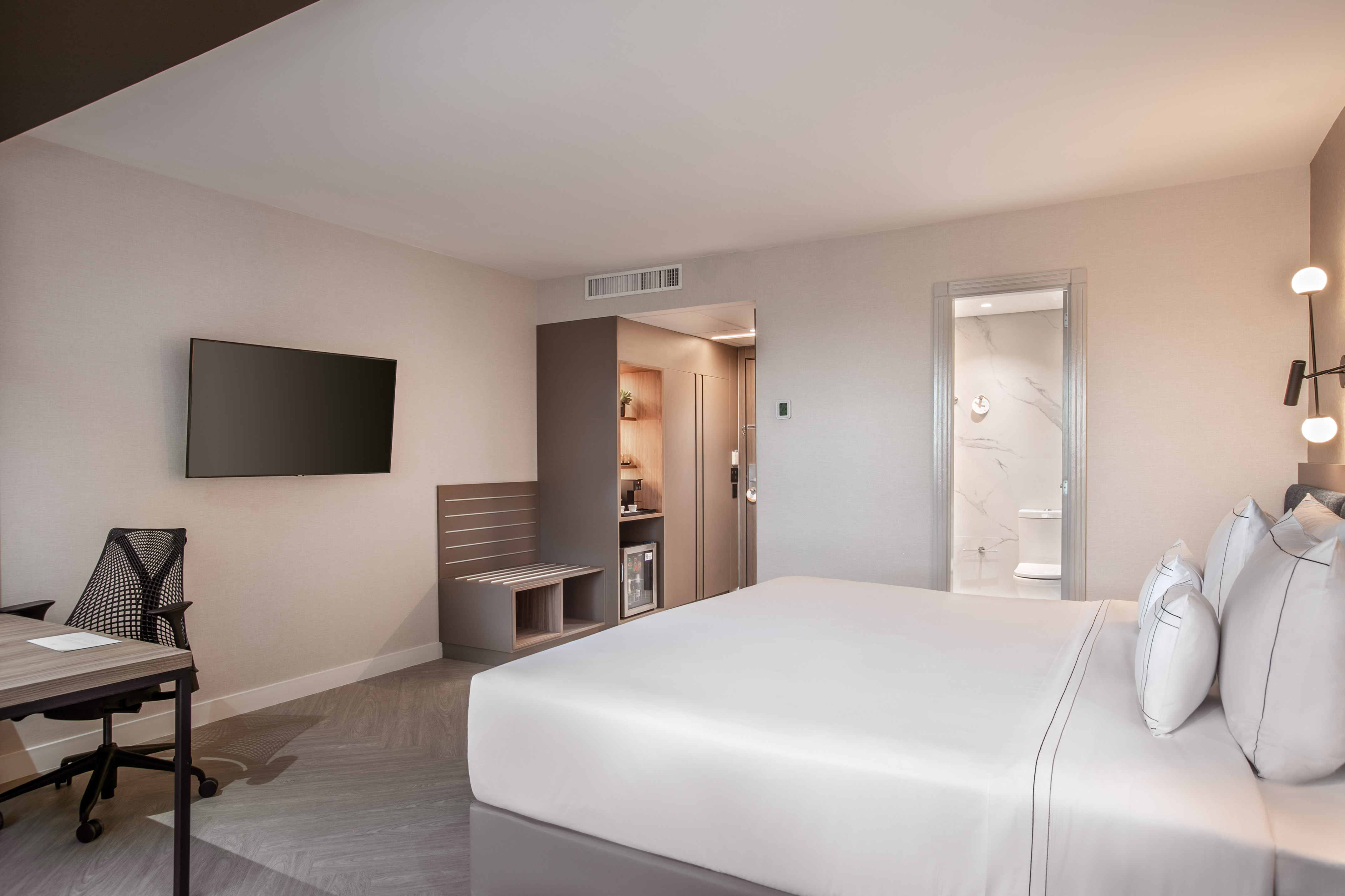 a room with a bed and a television