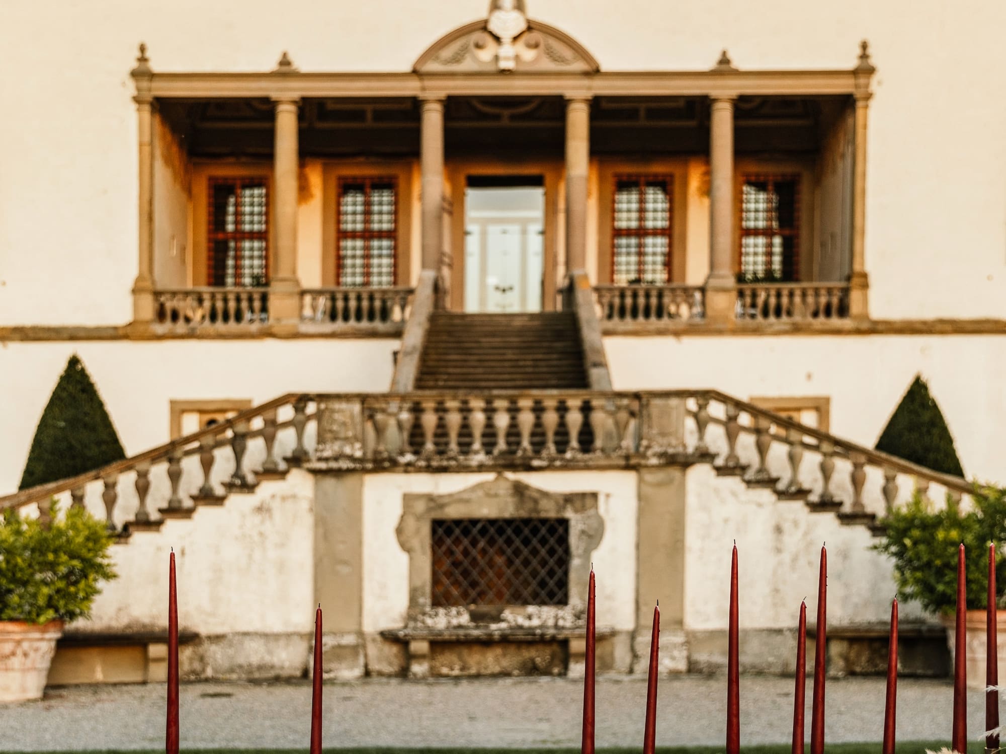 a large building with a staircase and a row of chairs