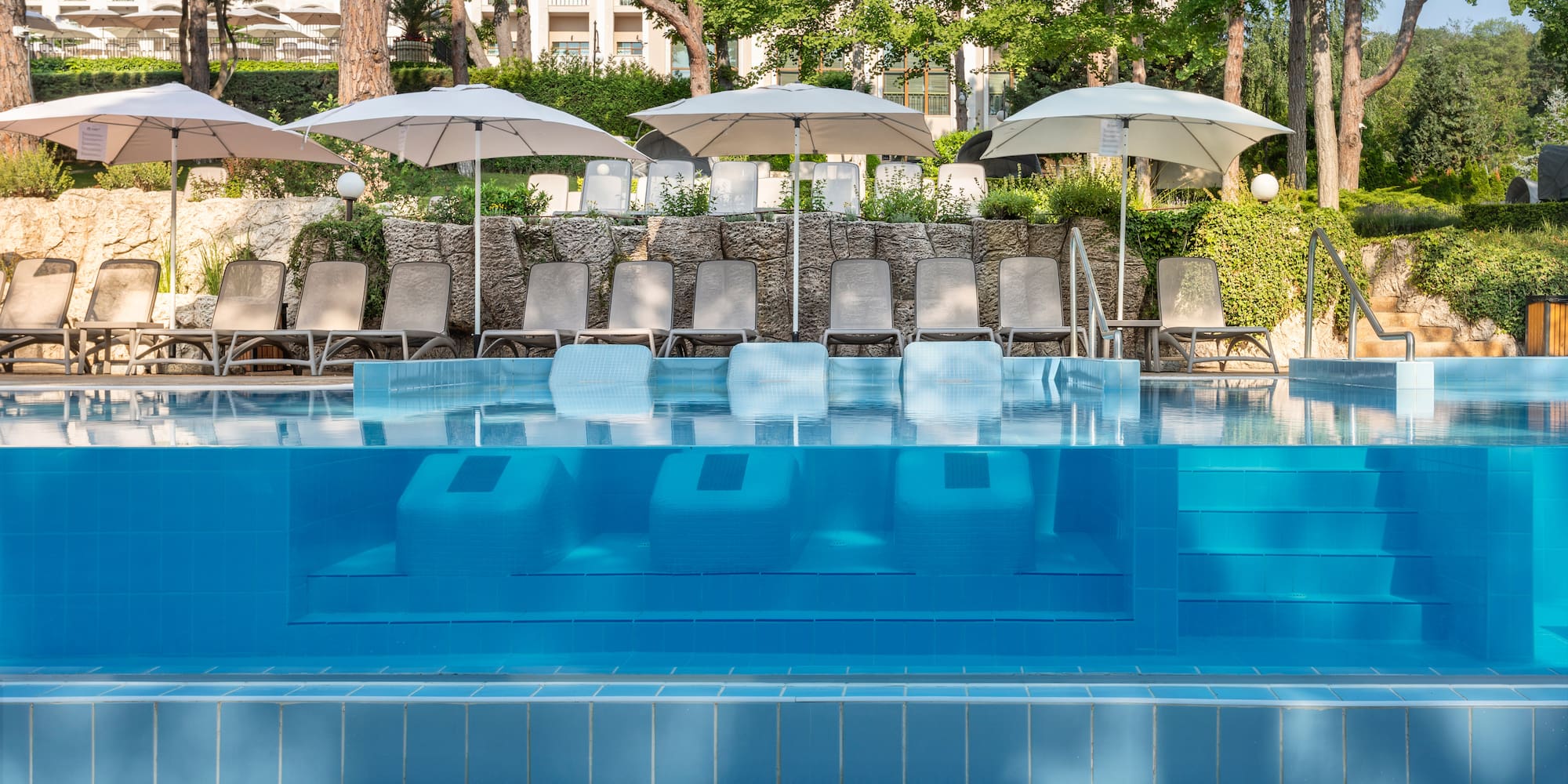 a pool with chairs and umbrellas
