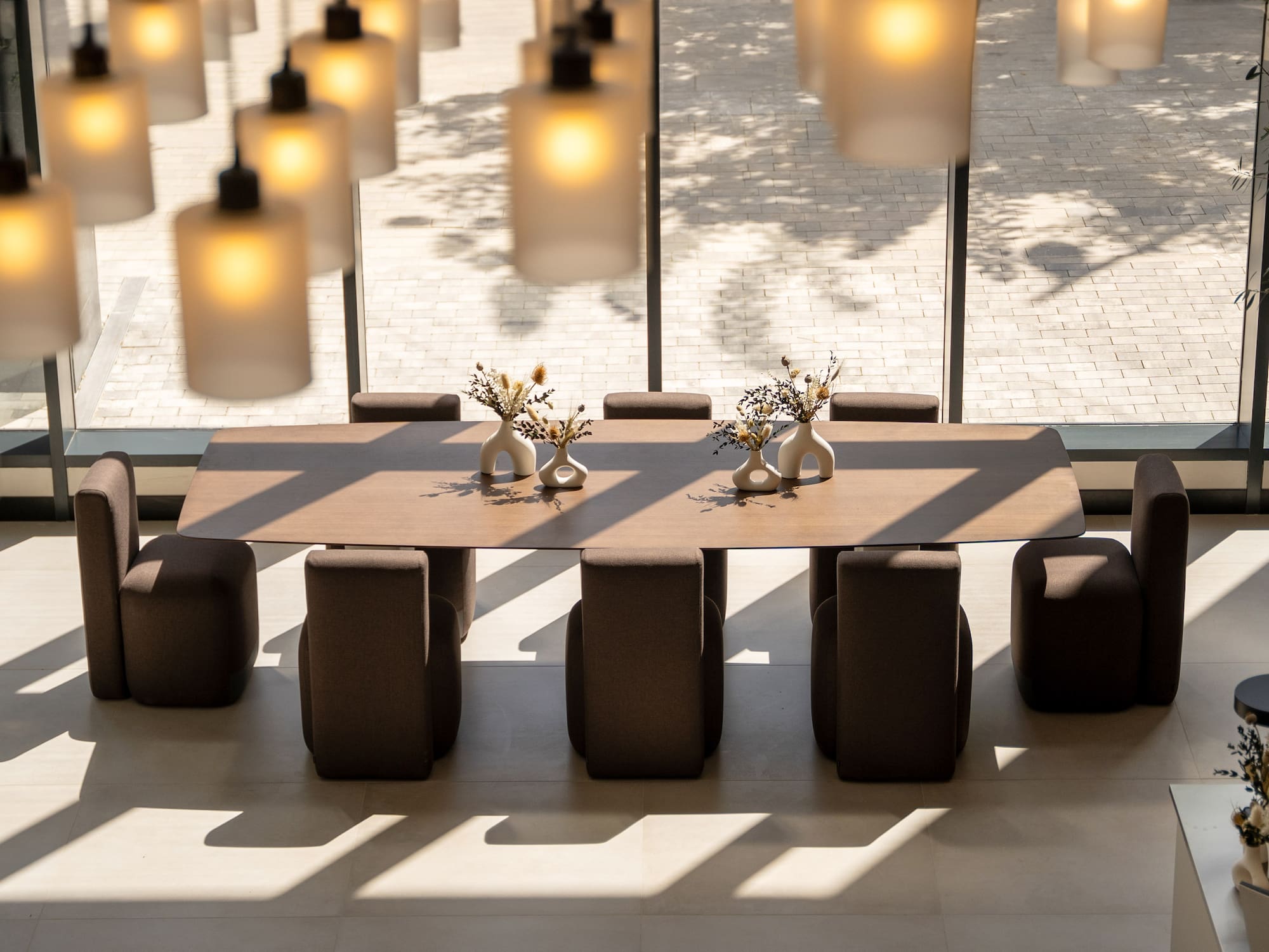 a table with chairs and vases on it