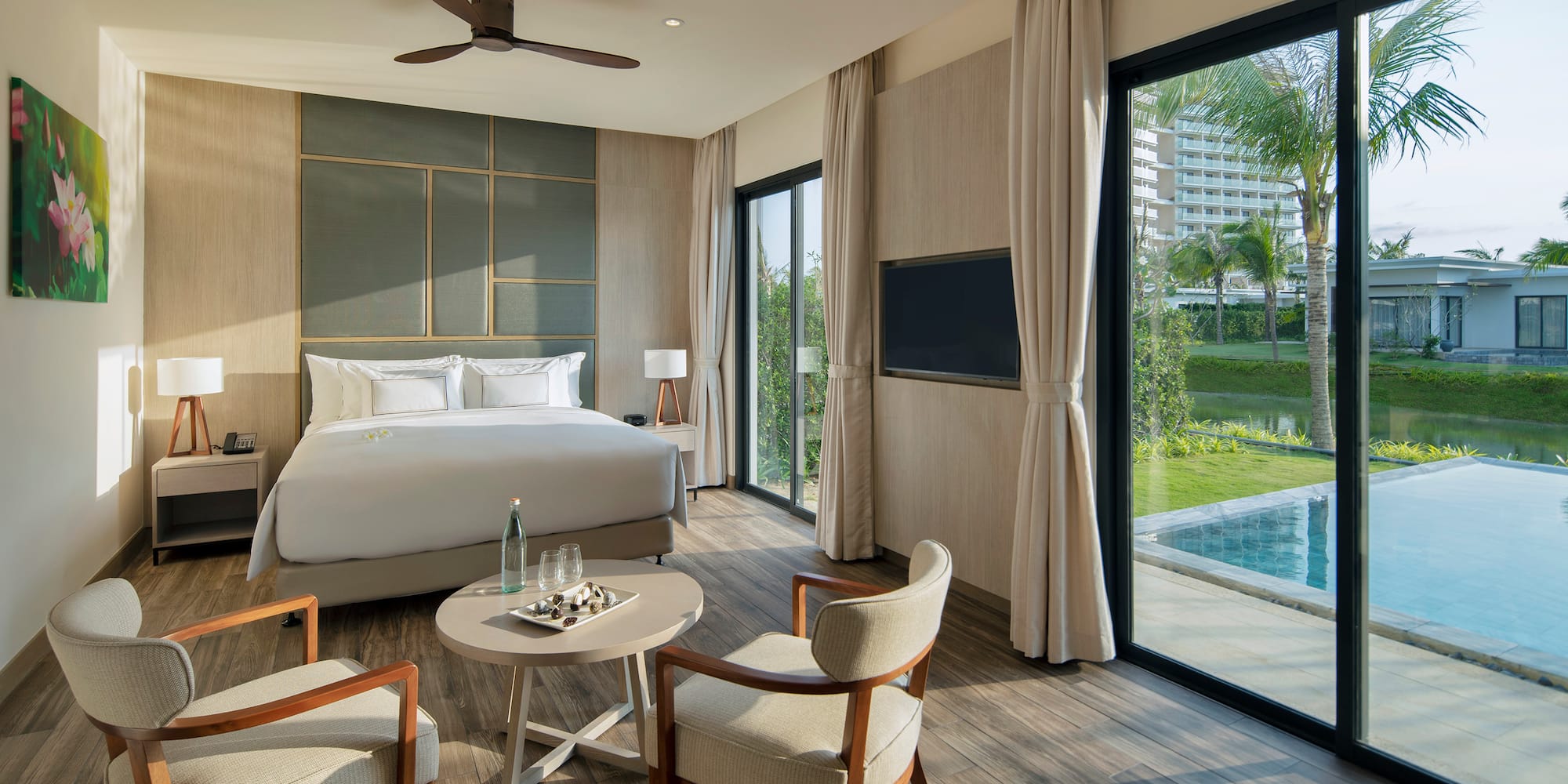 a room with a bed and chairs and a pool