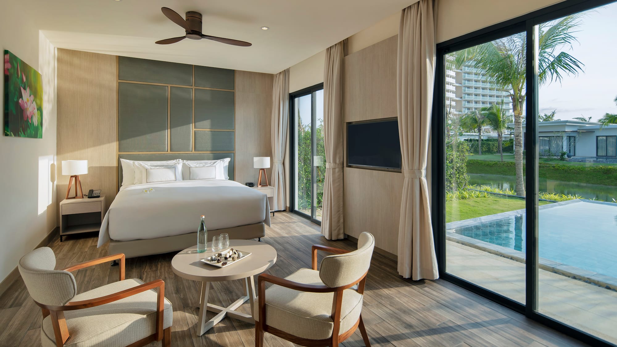 Luxury resort bedroom with private plunge pool, king bed, and tropical view.