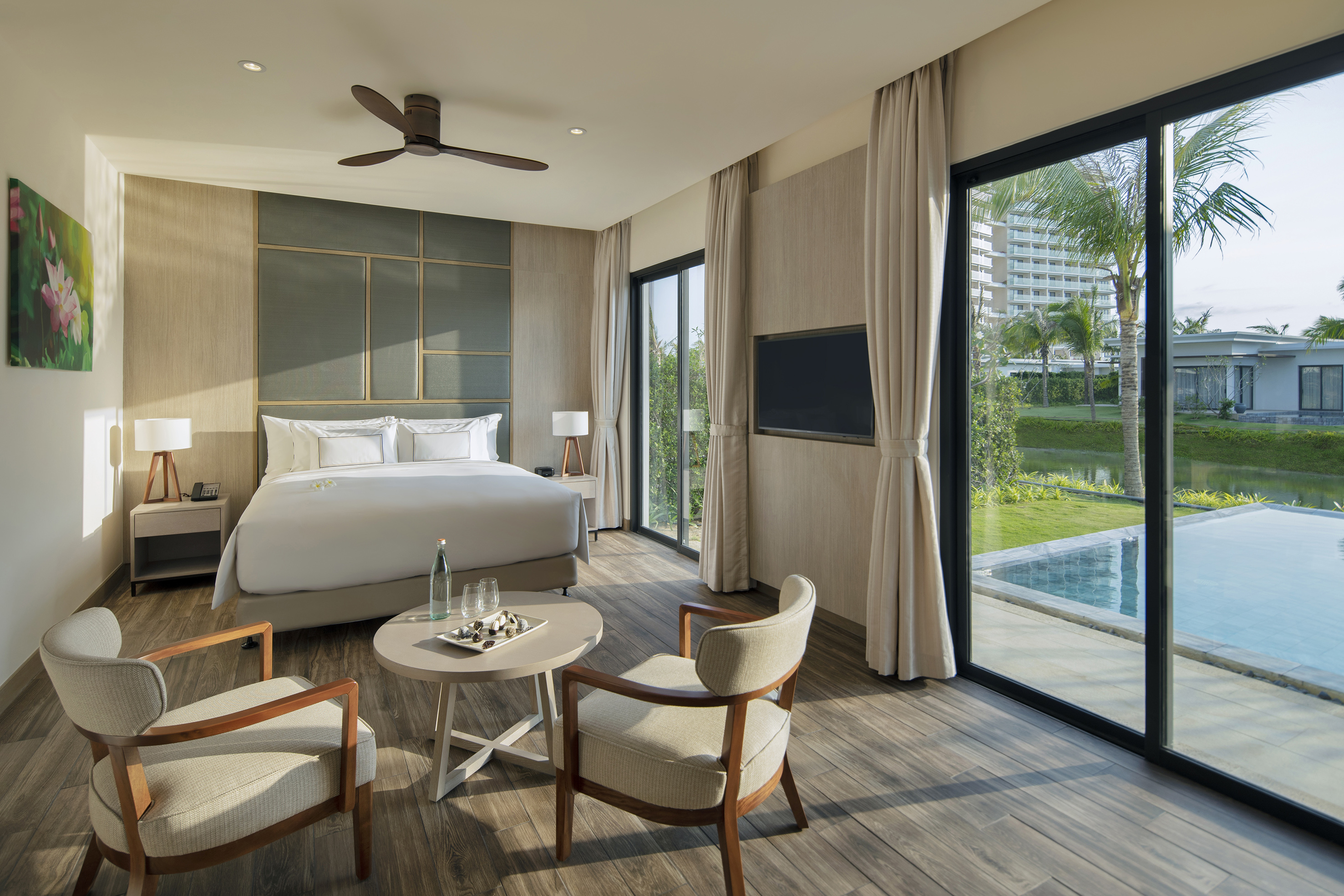 Luxury resort bedroom with private plunge pool, king bed, and tropical view.