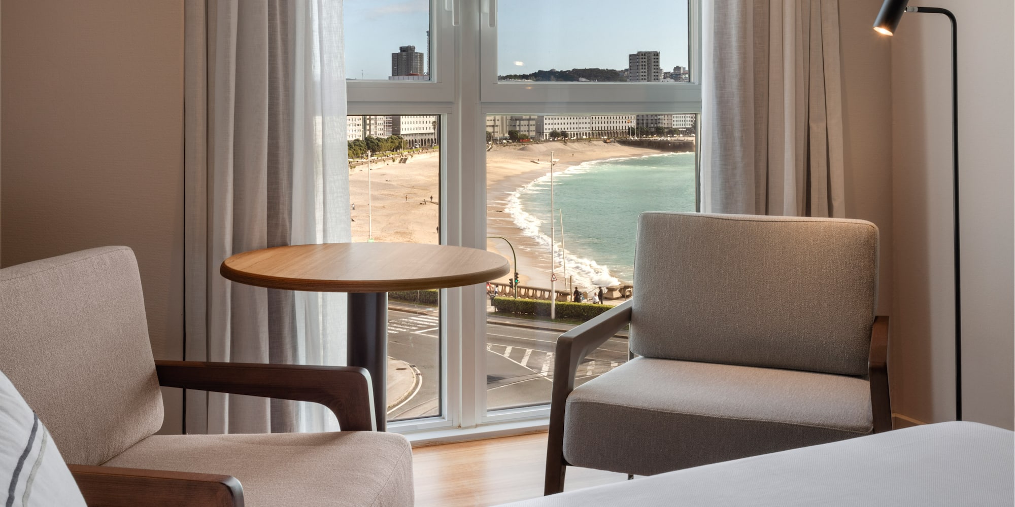 a room with a view of the beach and a table