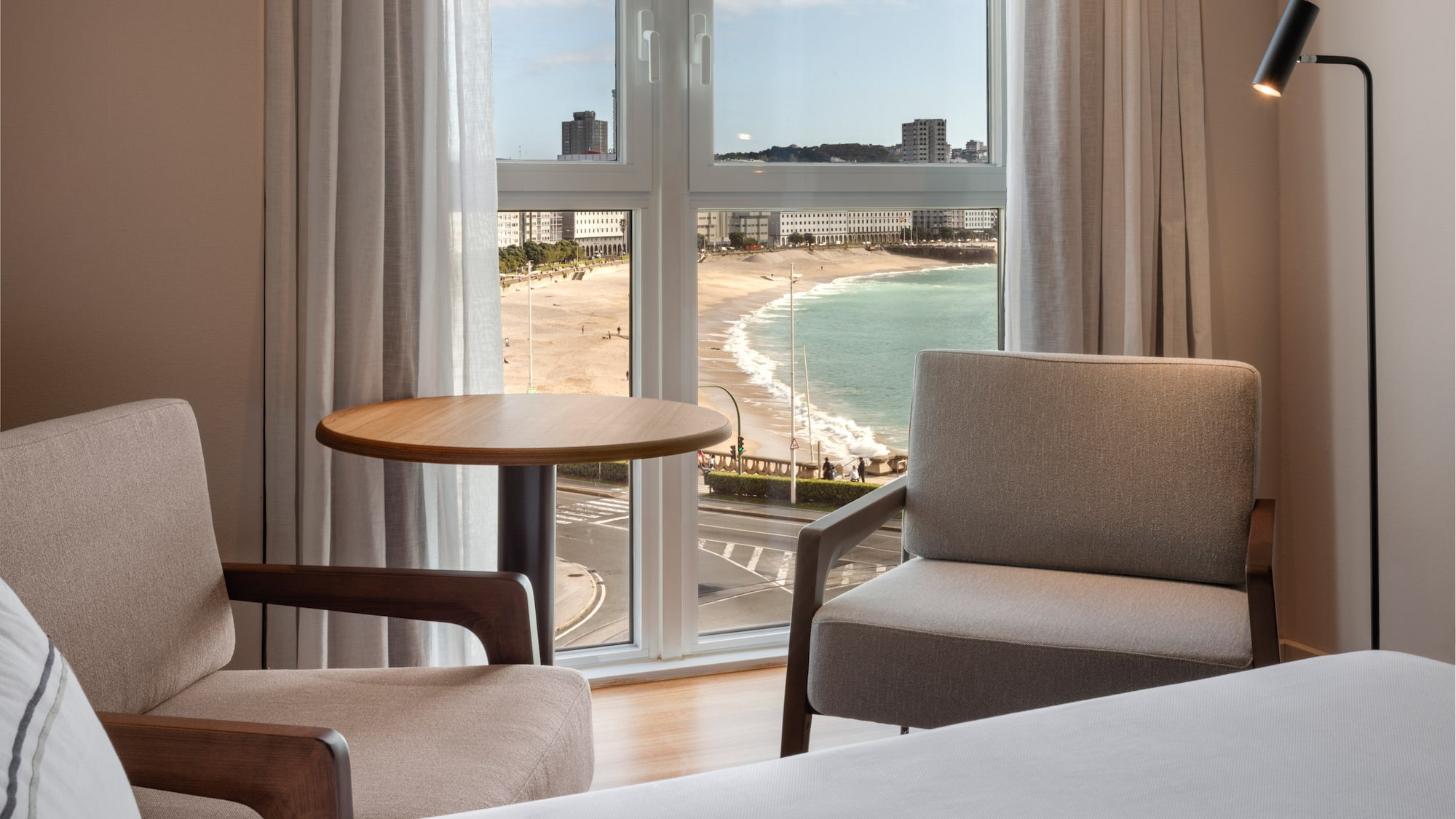 a room with a view of the beach and a table