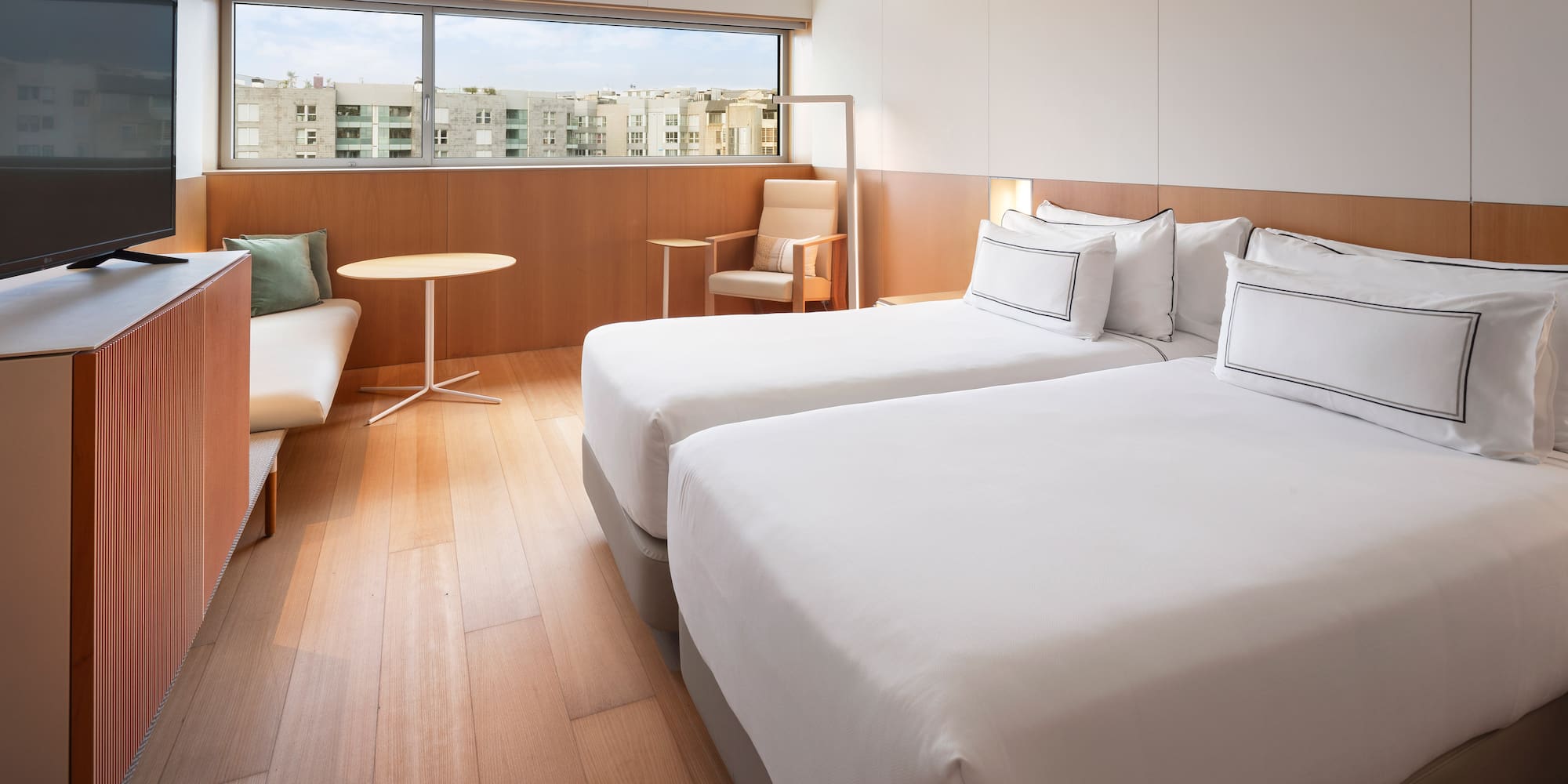 a room with two beds and a table