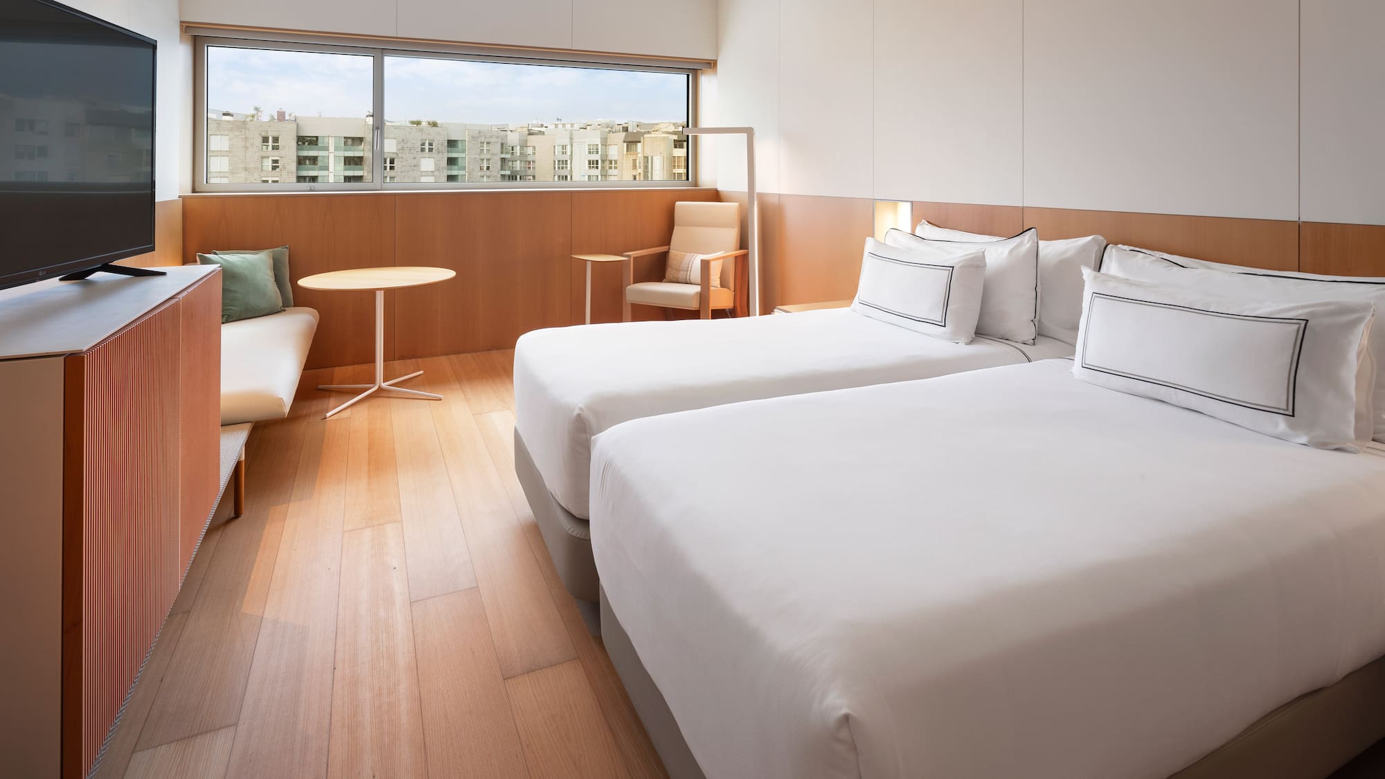 a room with two beds and a table