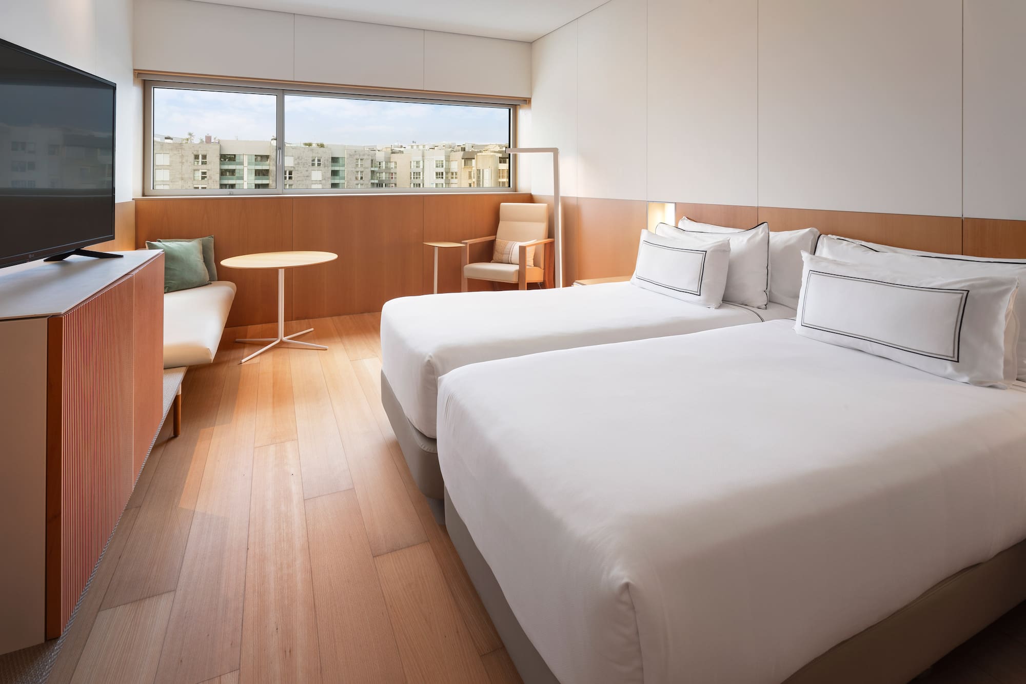 a room with two beds and a table