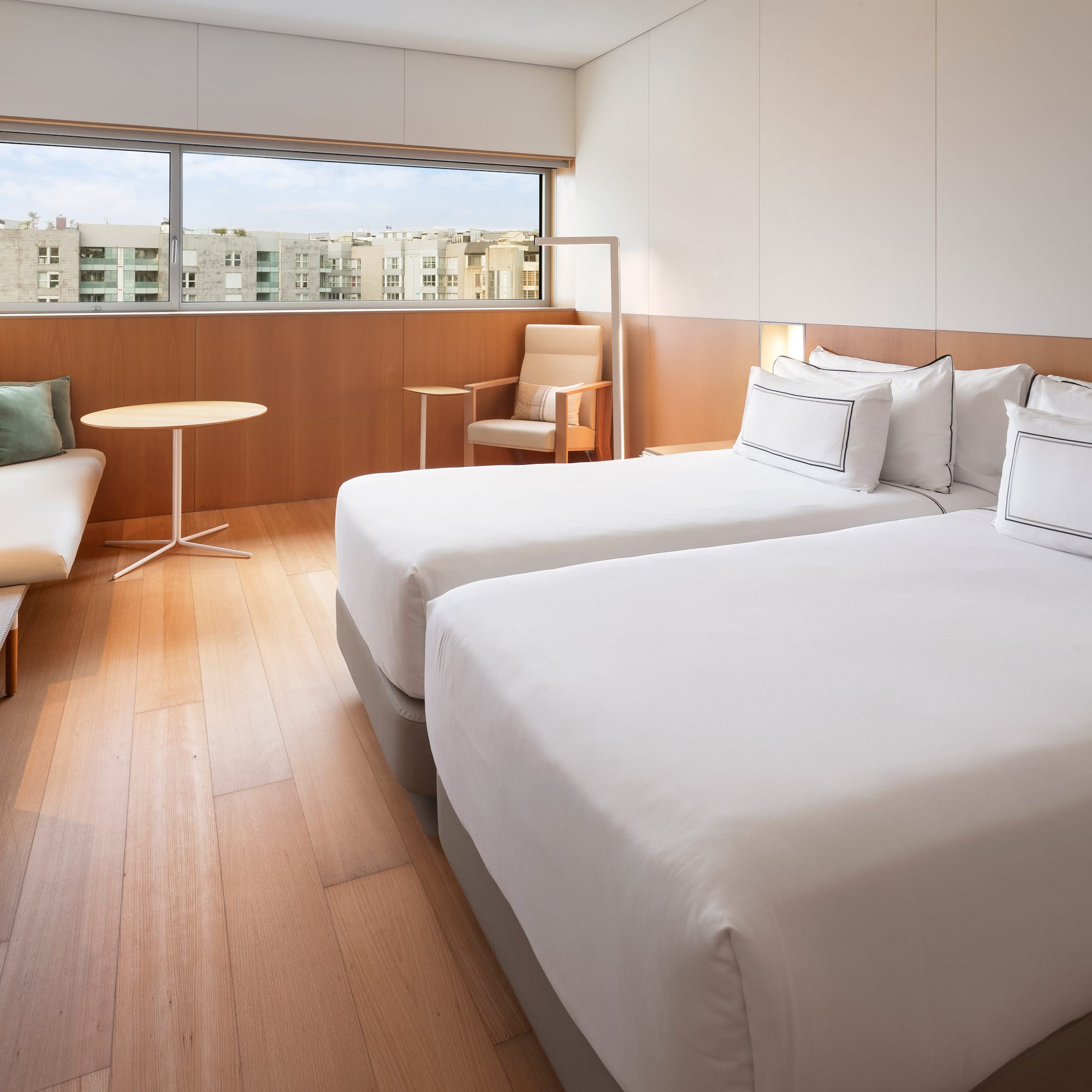 a room with two beds and a table