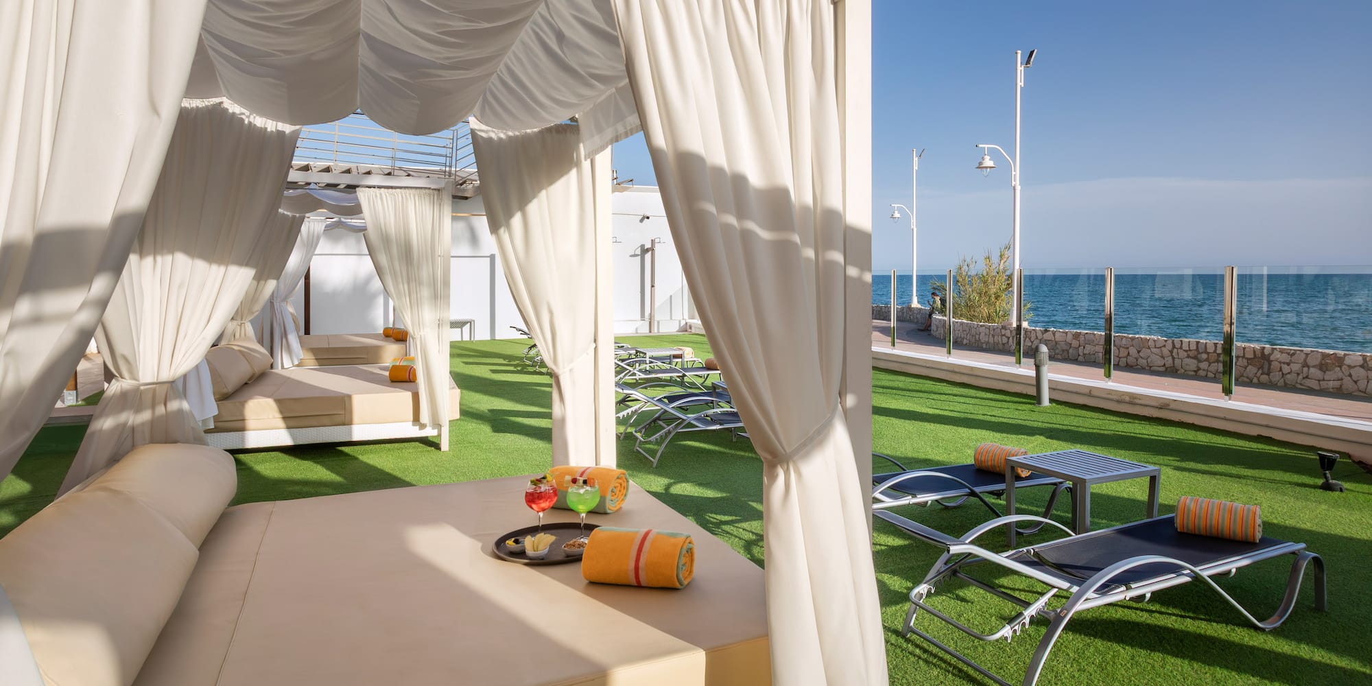 a lounge chairs and a table on a lawn