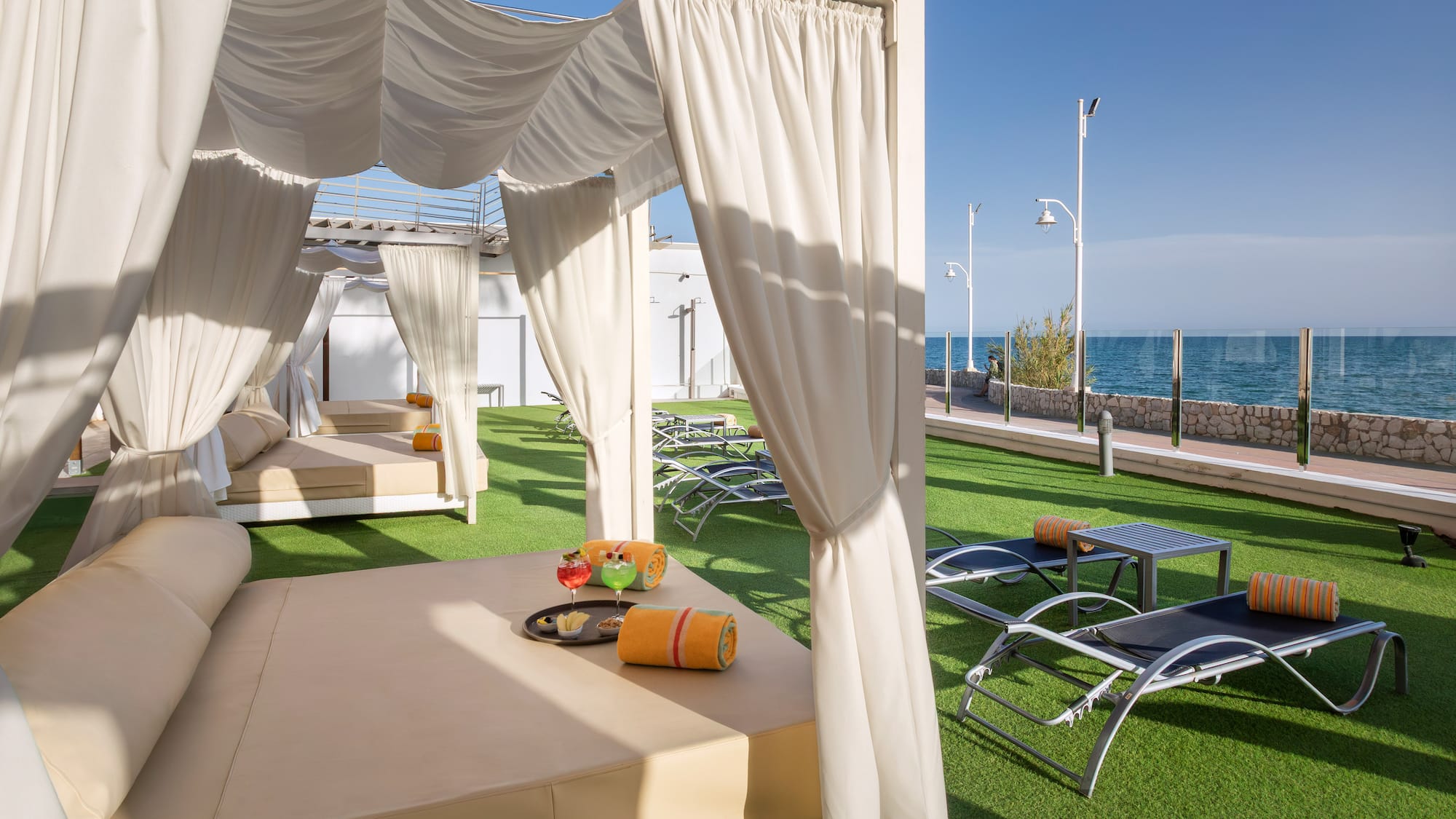 a lounge chairs and a table on a lawn