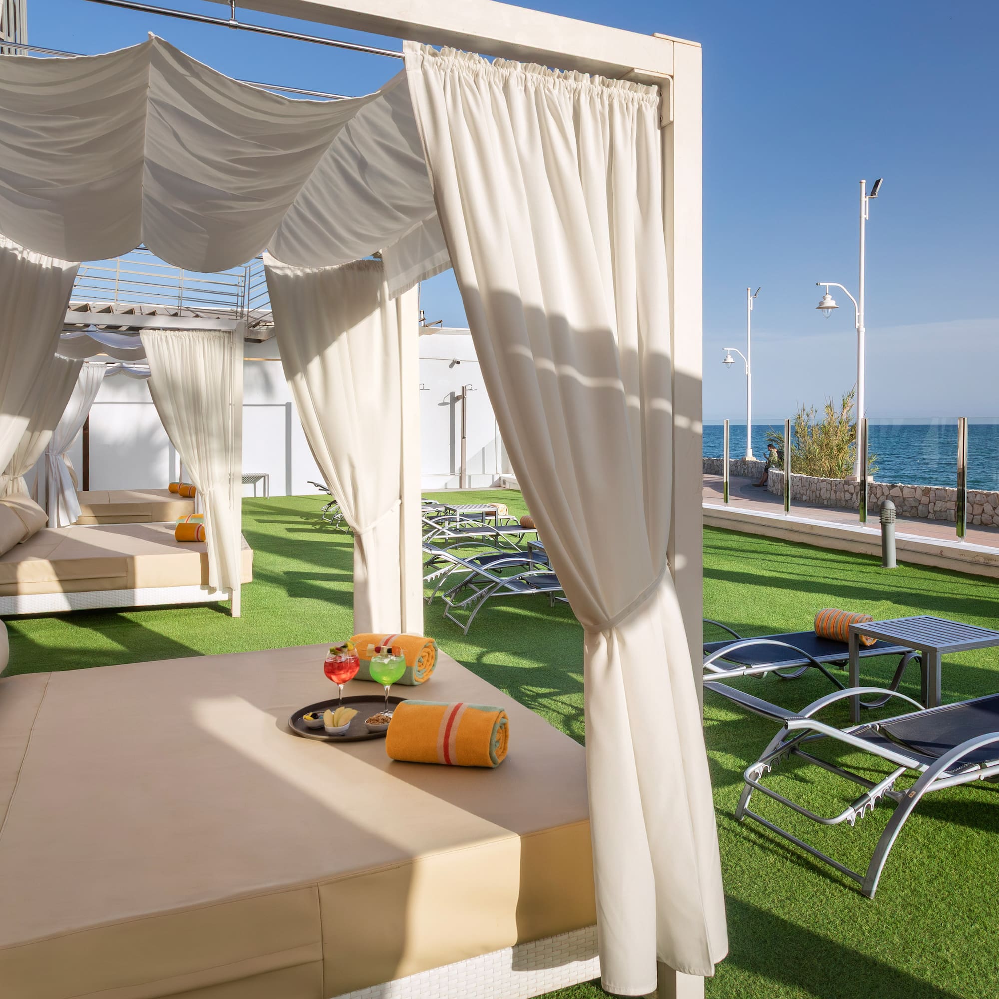 a lounge chairs and a table on a lawn