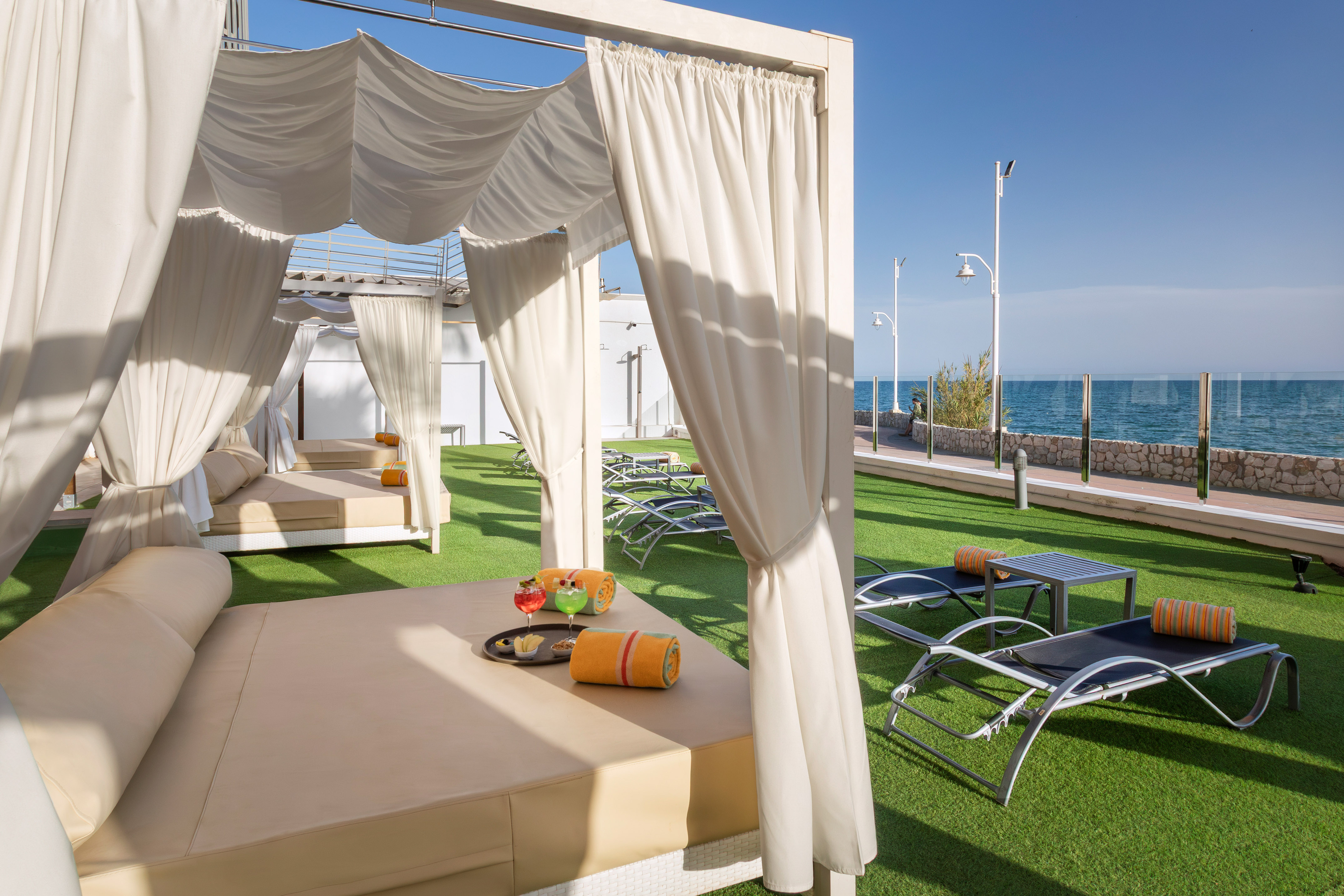 a lounge chairs and a table on a lawn