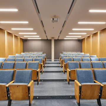 a room with blue chairs and a carpet