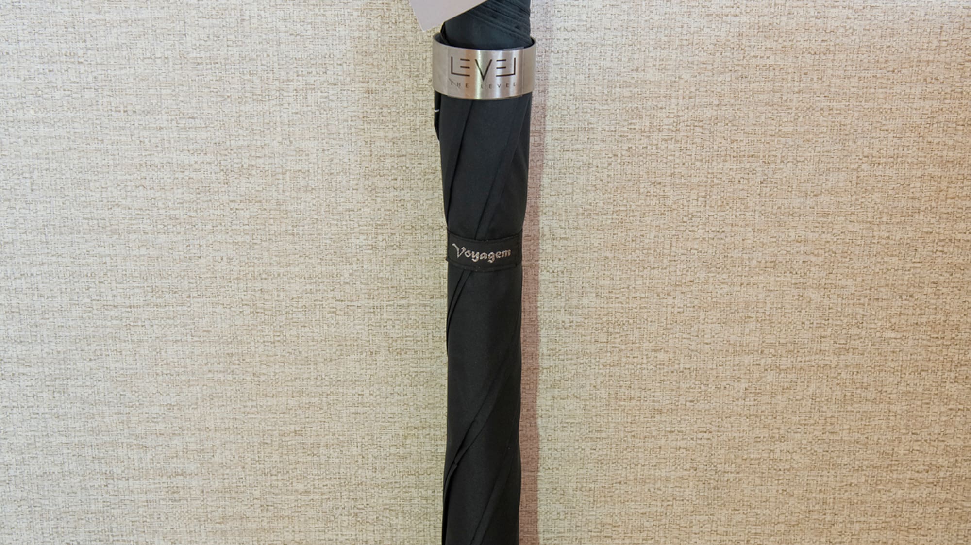 a black umbrella with a tag on it