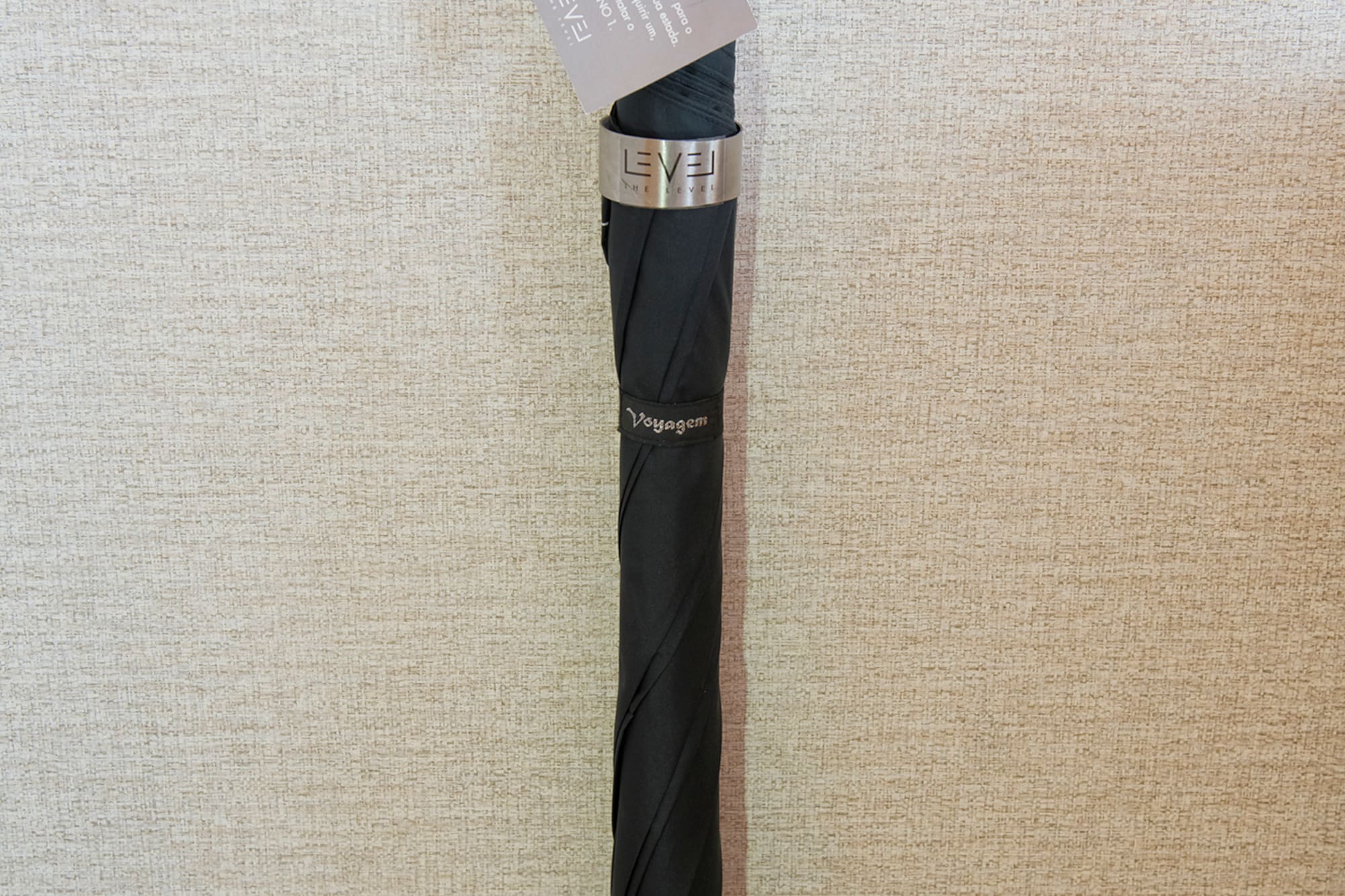 a black umbrella with a tag on it