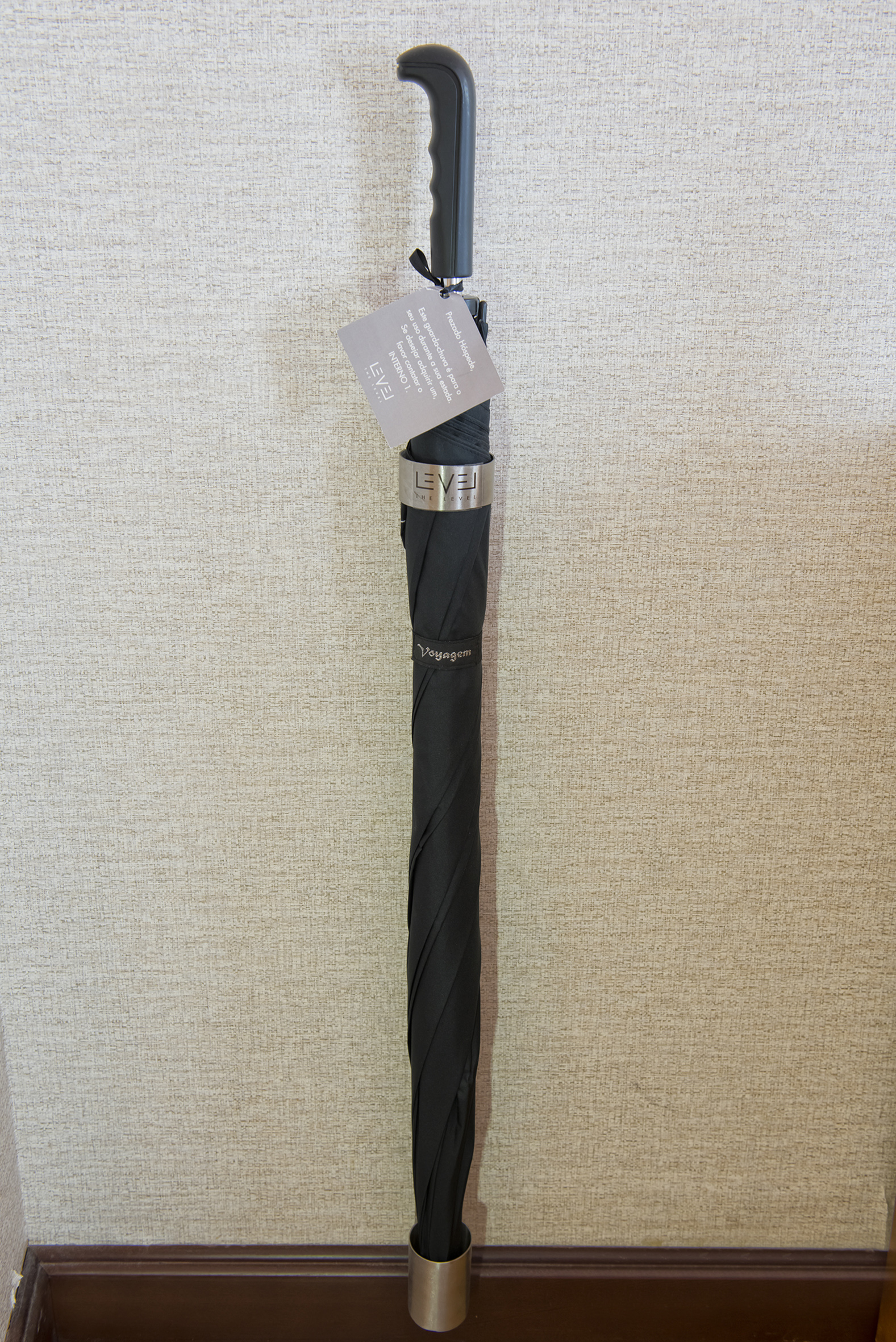 a black umbrella with a tag on it