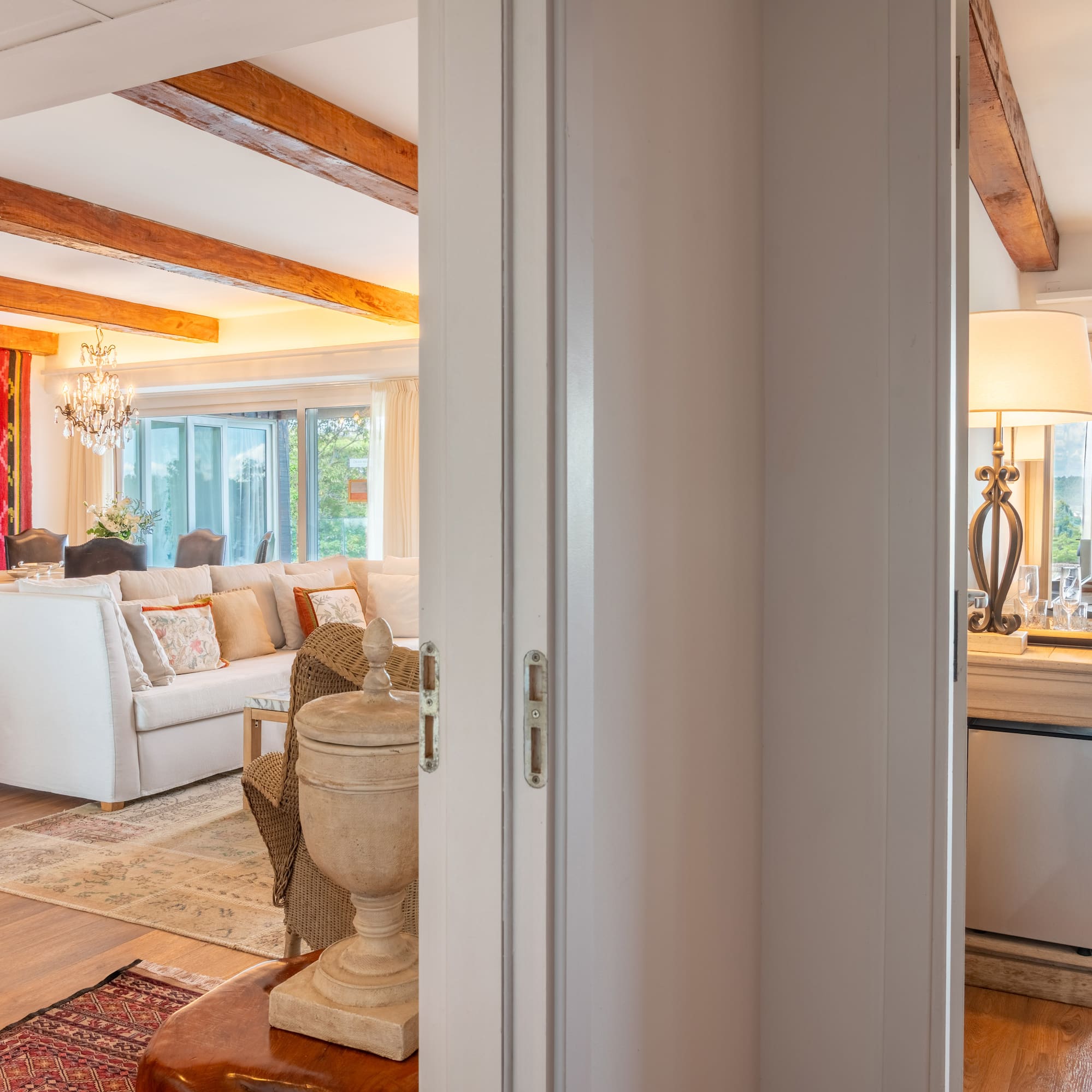 a room with a white couch and a large kitchen