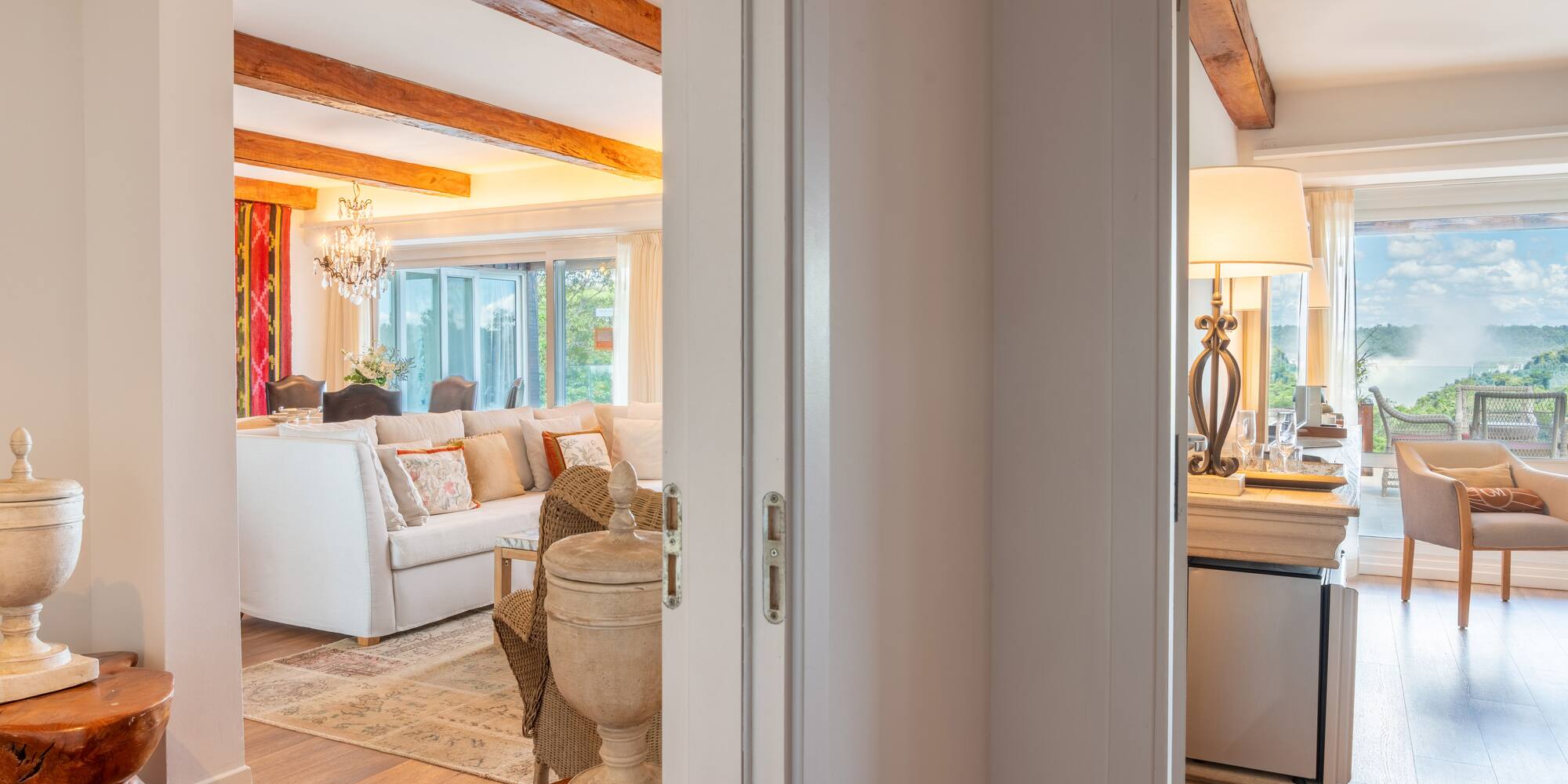 a room with a white couch and a large kitchen